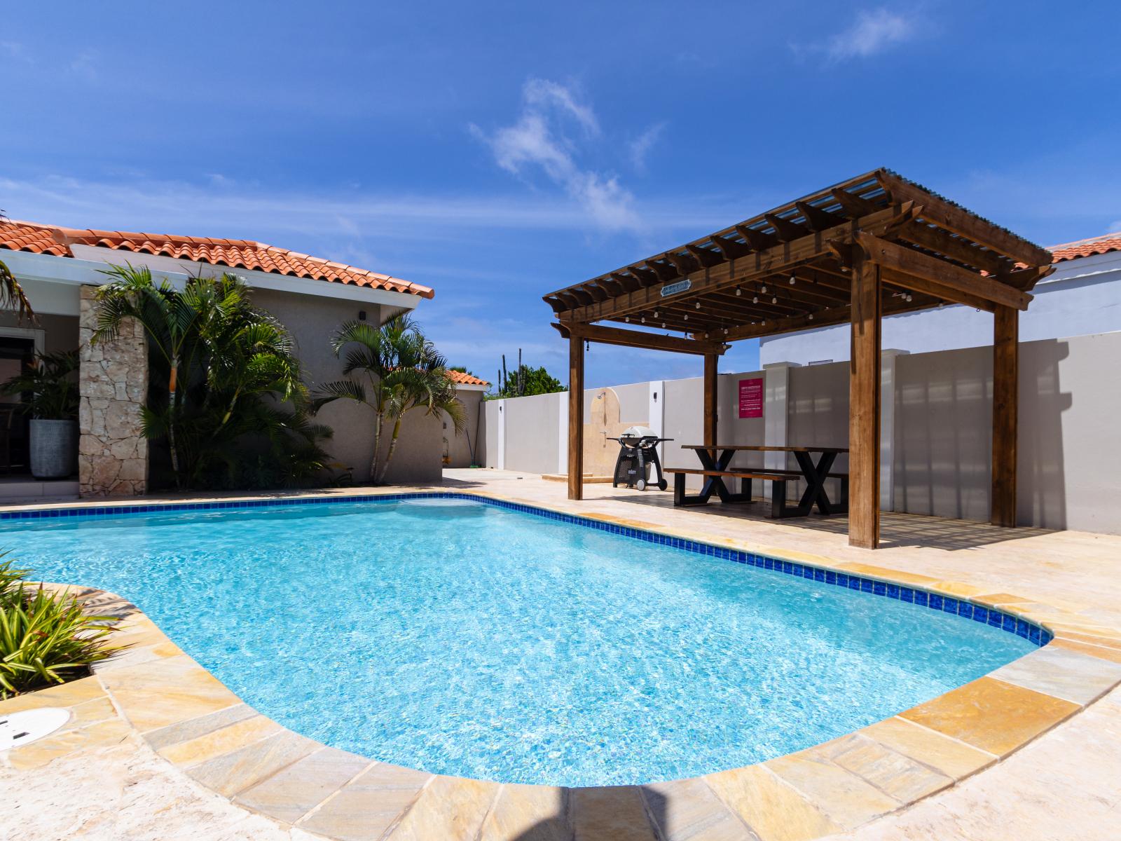 Luxury pool area of the apartment in Noord Aruba - Lush and refreshing environment - Beautifully sunbathed space makes the soul peaceful - Experience the comfort at the best