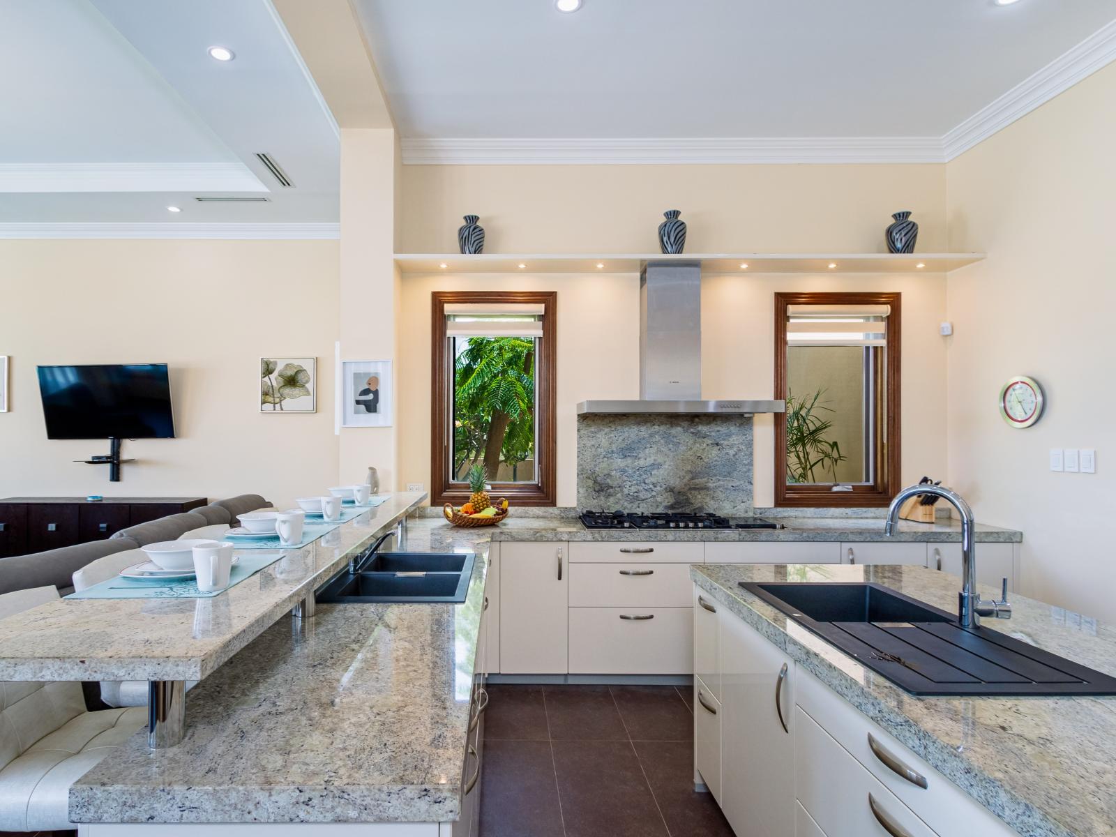 Elevate your culinary experience in our sleek, fully equipped kitchen with stainless steel appliances, perfect for preparing gourmet meals or quick snacks with ease.