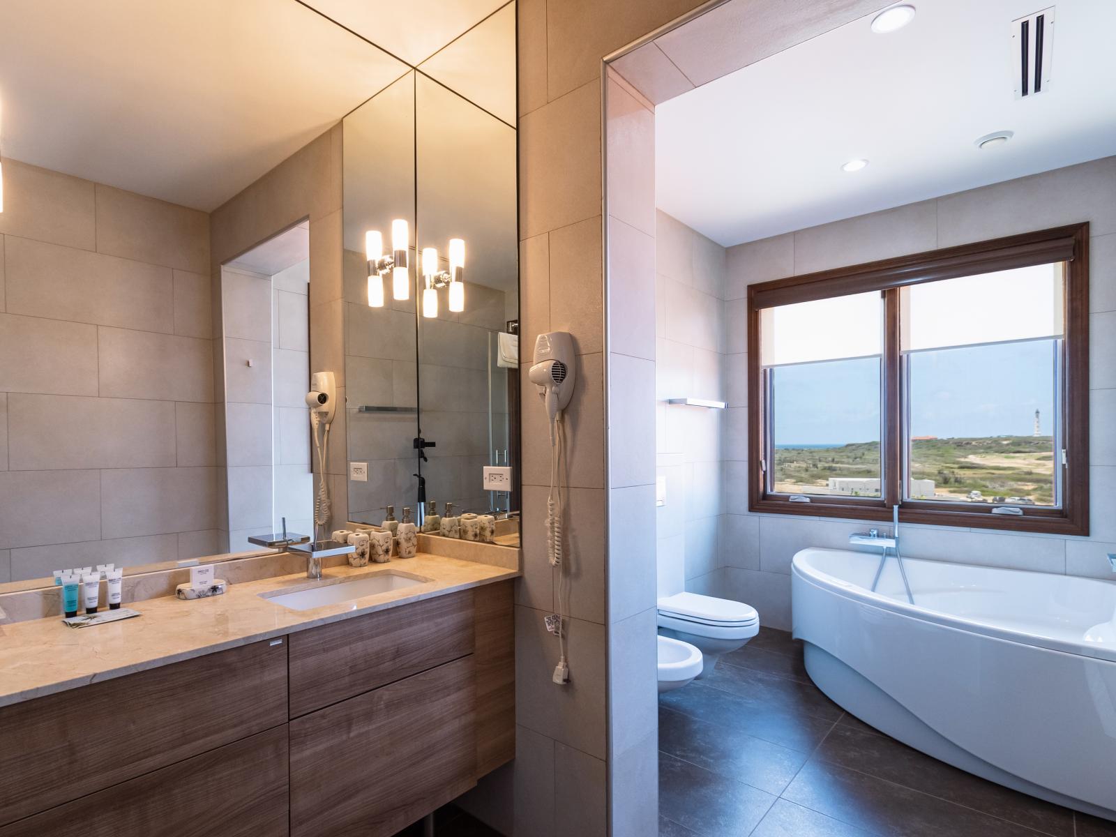 Pamper yourself with the best of both worlds in Bathroom 2, where a sumptuous bathtub awaits alongside a spacious walk-in shower. Experience the ultimate in comfort and convenience, allowing you to unwind exactly as you please, whenever you please.