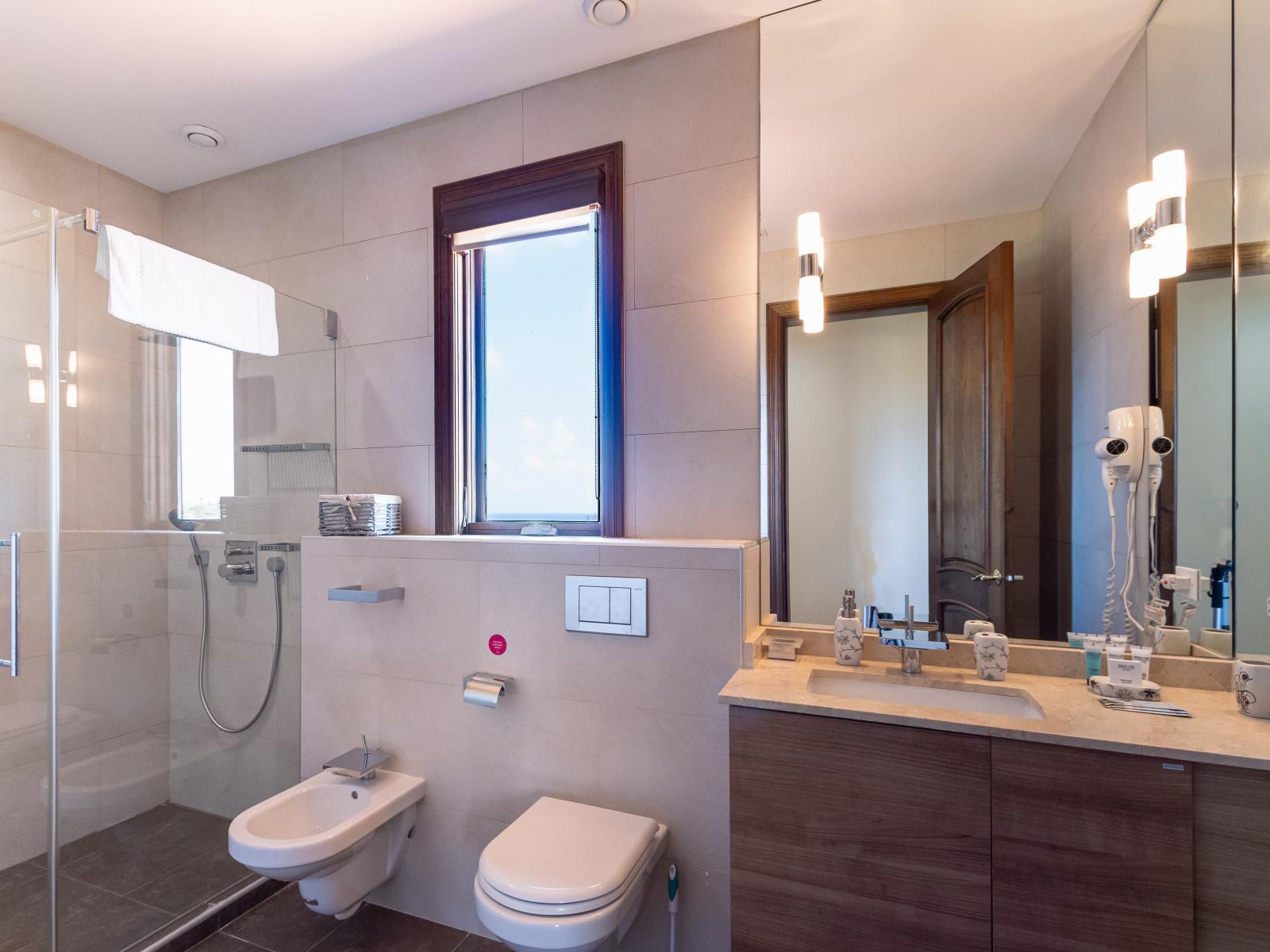 Indulge in tranquility in Bathroom 4, with contemporary fixtures and a serene ambiance, perfect for unwinding with a soak or starting your day refreshed.