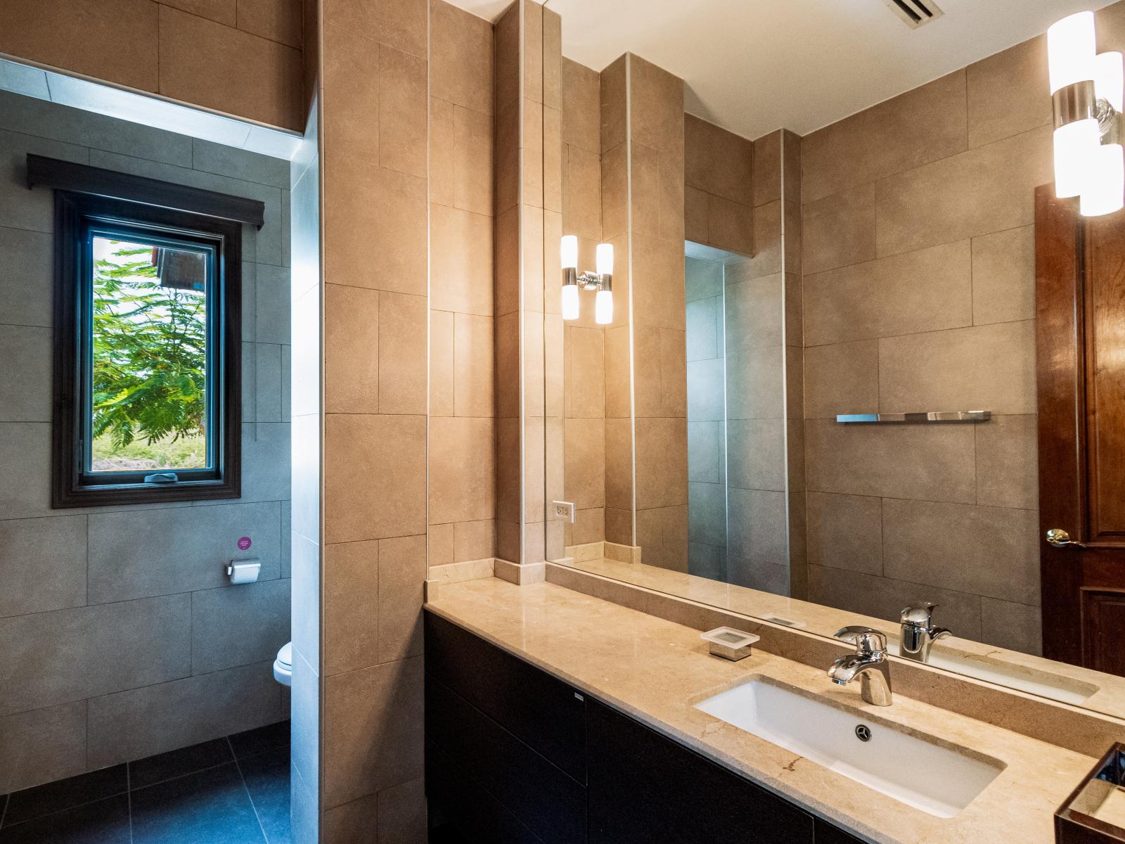 Escape to your personal oasis in our thoughtfully designed bathroom, offering a haven of comfort and style. With its spacious layout and upscale amenities, this tranquil space invites you to pamper yourself and unwind in pure bliss.