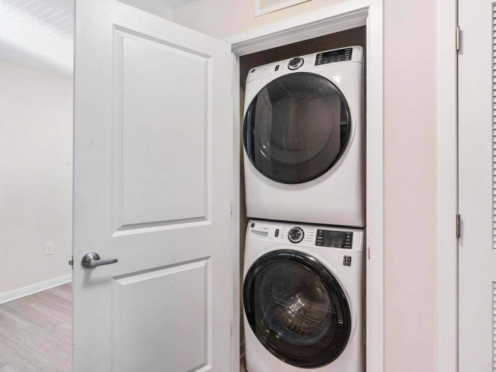 The laundry area boasts a full-size washer and dryer, ensuring that you can easily keep your clothes fresh and clean throughout your stay.