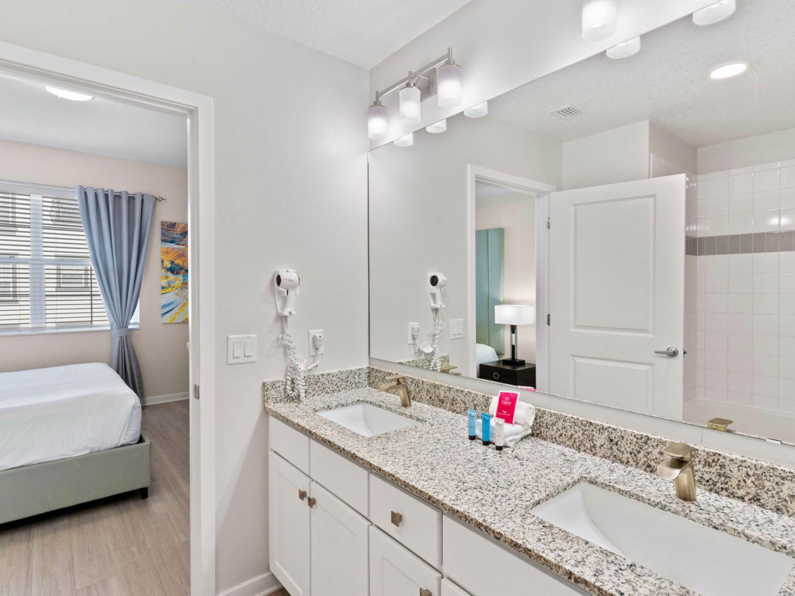 Indulge in relaxation with the luxurious Bathroom of the condo at Vista Cay Resort - Guests can unwind and pamper themselves in the comfort of the main bathroom - Lovely vanity with twin sink - Sufficient storage space