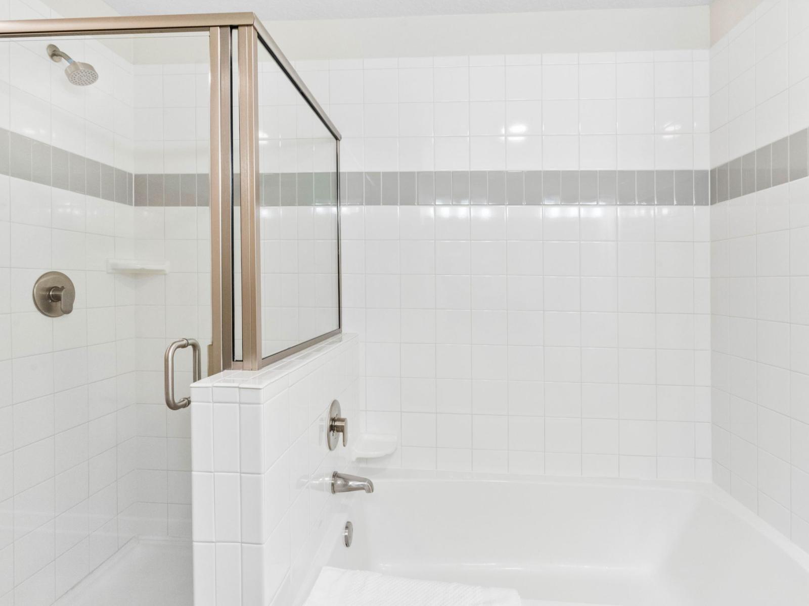 Relax and unwind in the deep soaking tub of the main bathroom, offering a serene retreat after a long day.