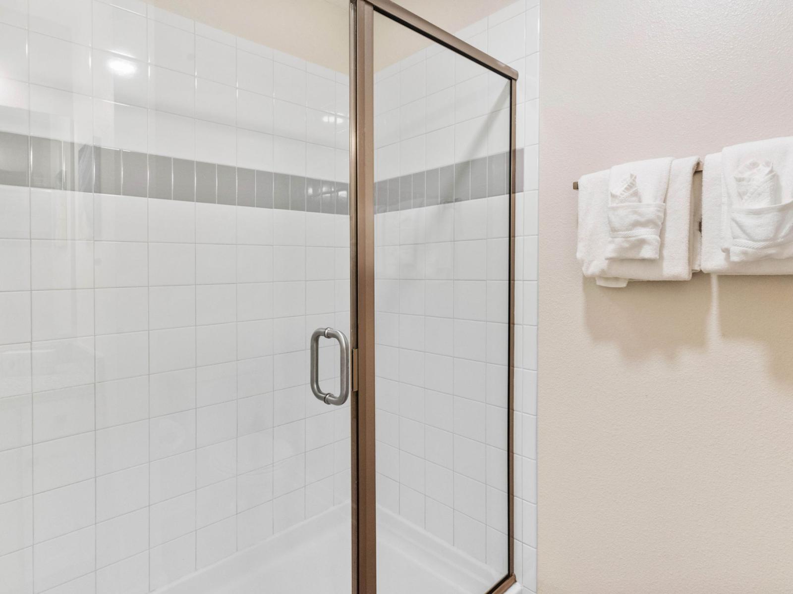 This toilet and bath, featuring a sleek shower enclosure, offers a refreshing retreat where modern design meets functionality, providing a rejuvenating space to start and end the day.