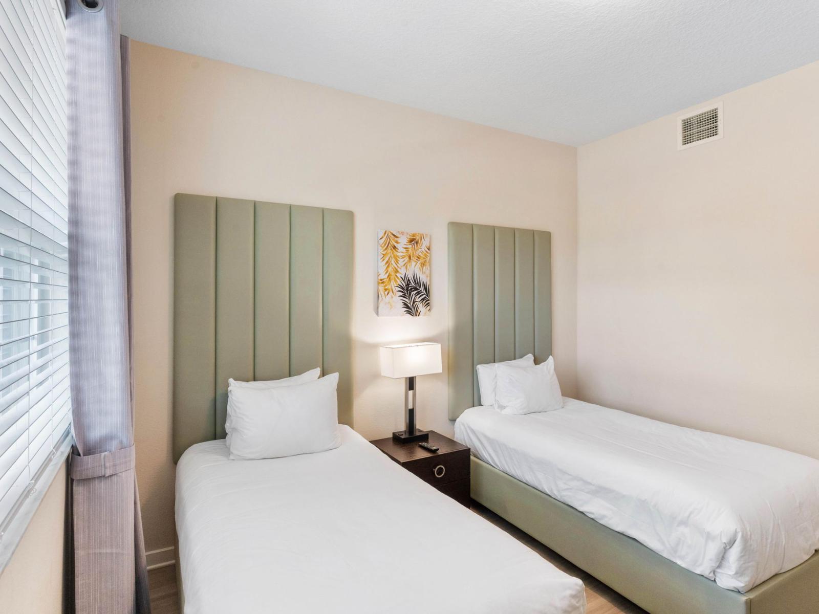 Cozy Comfort: Bedroom 3 offers ample space and features two beds, perfect for a restful night's sleep.