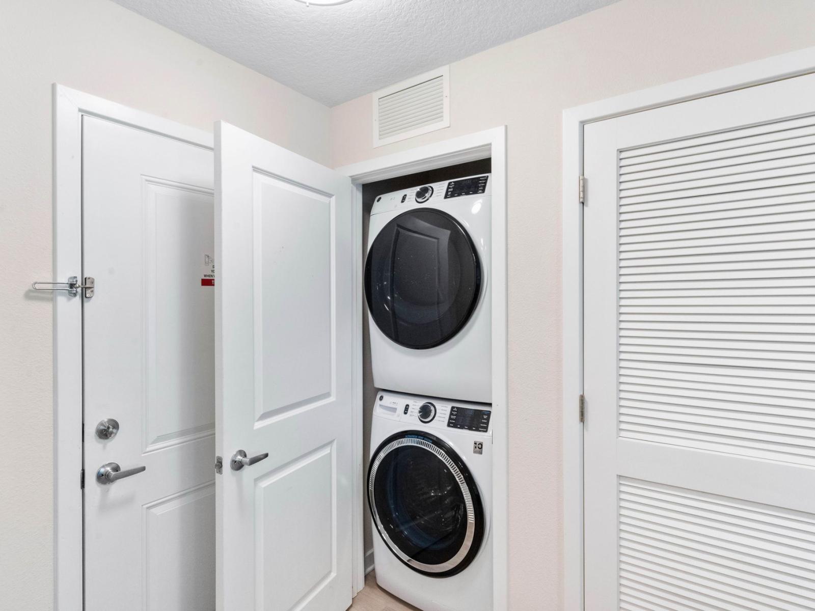 The laundry area boasts a full-size washer and dryer, ensuring that you can easily keep your clothes fresh and clean throughout your stay.