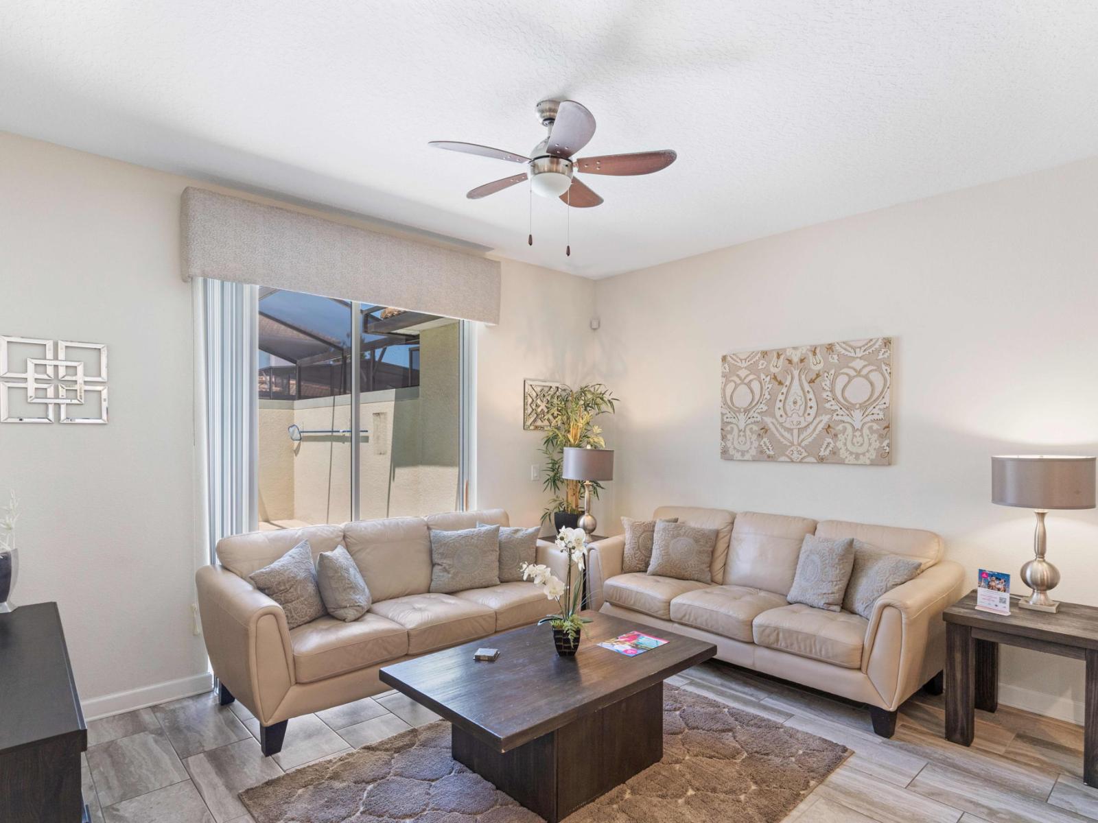 Enchanting living area of the town house in Kissimmee Florida - Natural light floods the room, enhancing its warmth and inviting atmosphere - Smart TV and Netflix - Stylish furniture arrangement providing comfort and a cohesive look