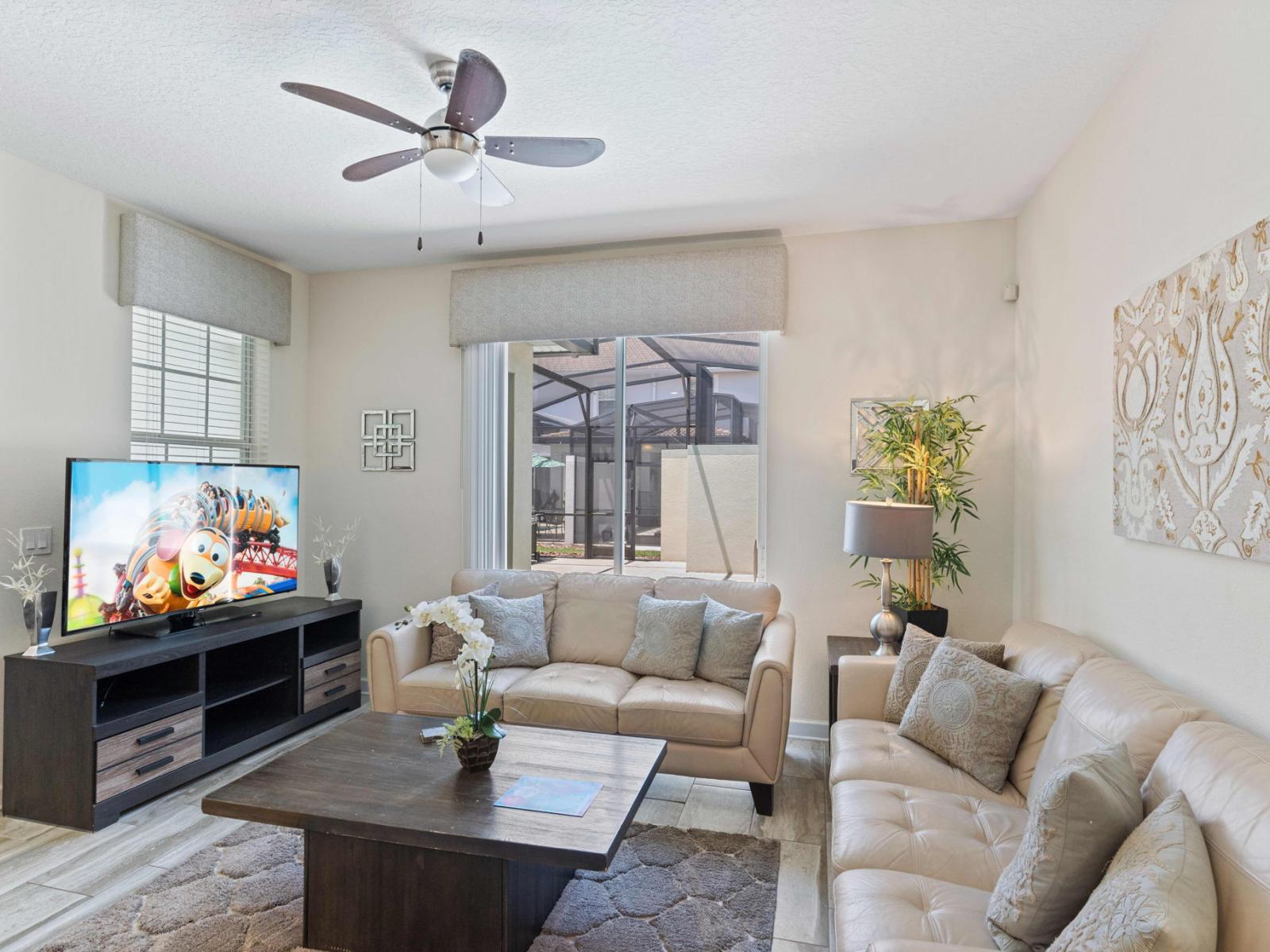 Radiant of the town house in Kissimmee Florida - Stylish furniture arrangement providing comfort and a cohesive look - Cozy seating and smart TV for entertainment - A balance of sophistication and comfort, featuring elegant yet inviting furniture