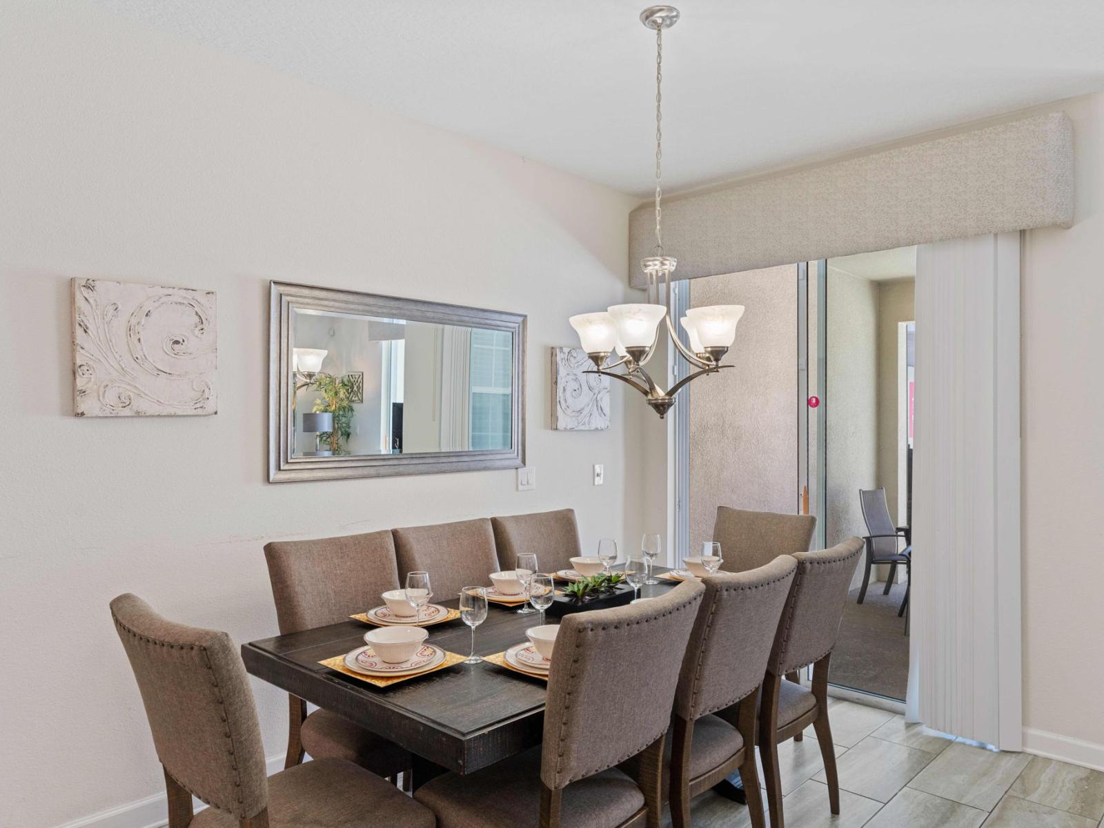 Sleek dining area of the town house in Kissimmee Florida - 8 Persons Dining - Sophisticated design with a blend of modern and classic elements - Intimate ambiance created through soft, lighting