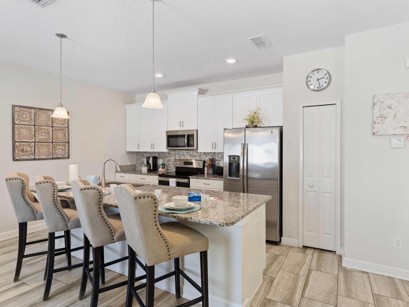 - Fully equipped kitchen of the town house in Kissimmee Florida - Integrated appliances for a seamless and stylish appearance - Thoughtful placement of kitchen essentials for easy access - Coordinated decor for a polished and inviting atmosphere