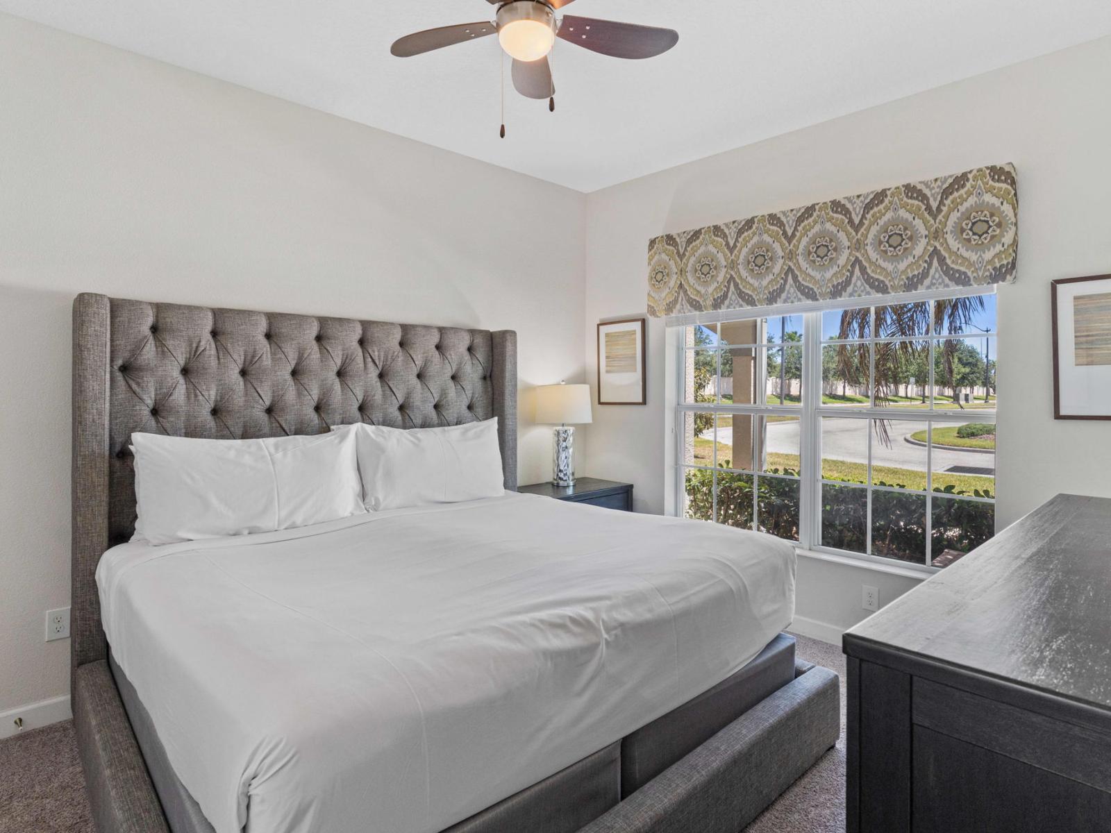 Beautiful bedroom of the town house in Kissimmee Florida - Minimalist decor, creating a clean and uncluttered sleeping space - Cozy double bed and smart TV for entertainment - Bedroom with a cozy ambiance, blending comfort and aesthetics