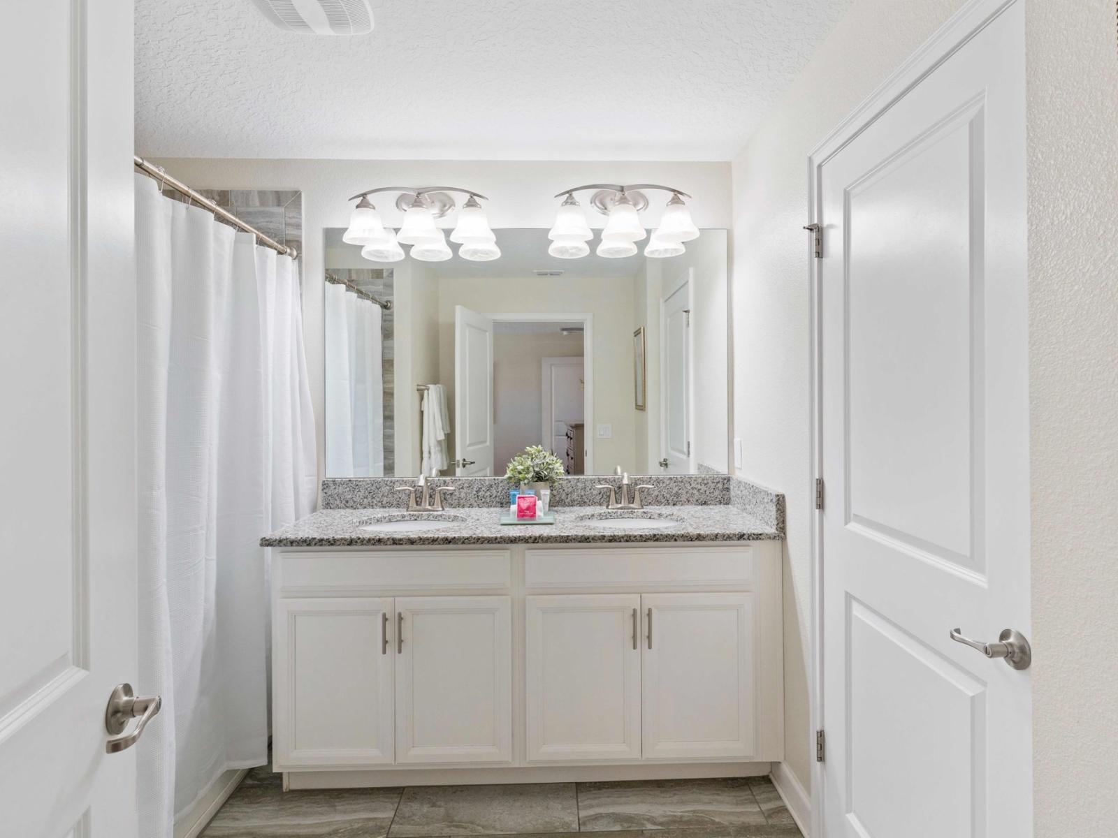 Indulge in the luxurious Main Bathroom, featuring a seamless blend of convenience and relaxation with its harmonious combination of a refreshing shower and a soothing bathtub, creating a spa-like retreat.