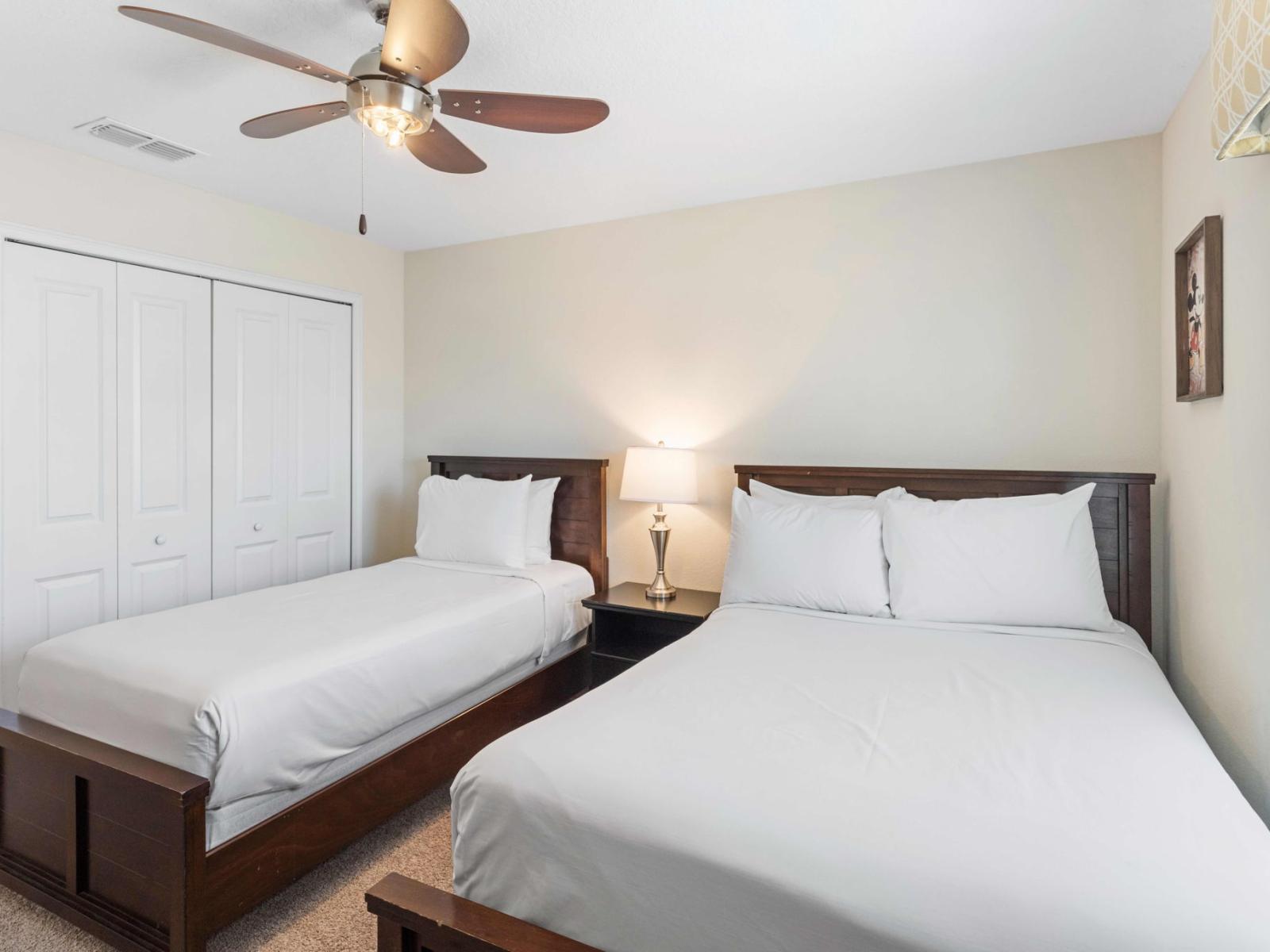 Lofty bedroom of the town house in Kissimmee Florida - One single bed and one double bed - Cozy and inviting ambiance for relaxation - Harmonious color palette creating a soothing atmosphere