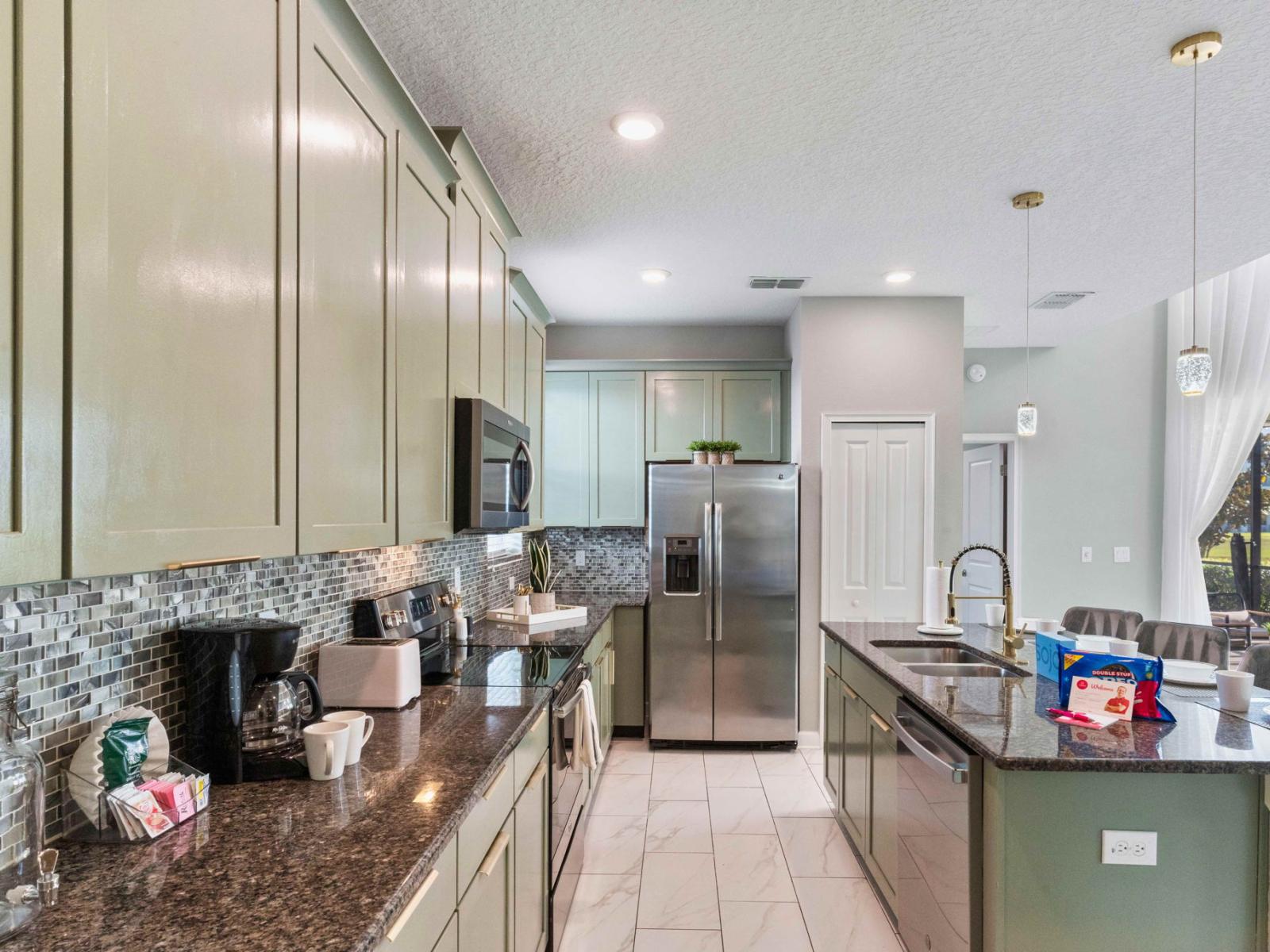 Lush kitchen of the home in Kissimmee Florida - Experience culinary excellence in the kitchen area, featuring sleek stainless steel appliances - Modern functionality meets contemporary design, creating the perfect space