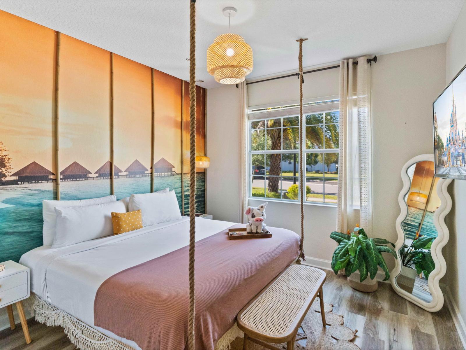 Tropical themed bedroom of the home in Kissimmee Florida - Thoughtfully designed bedroom featuring functional and stylish furniture - Full length mirror and smart TV - Modern and stylish decor that complements the space