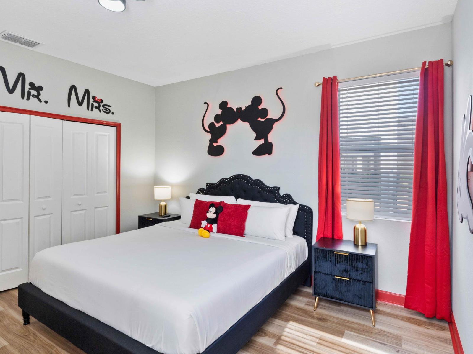 Mickey and Minnie themed bedroom with king size bed and smart TV