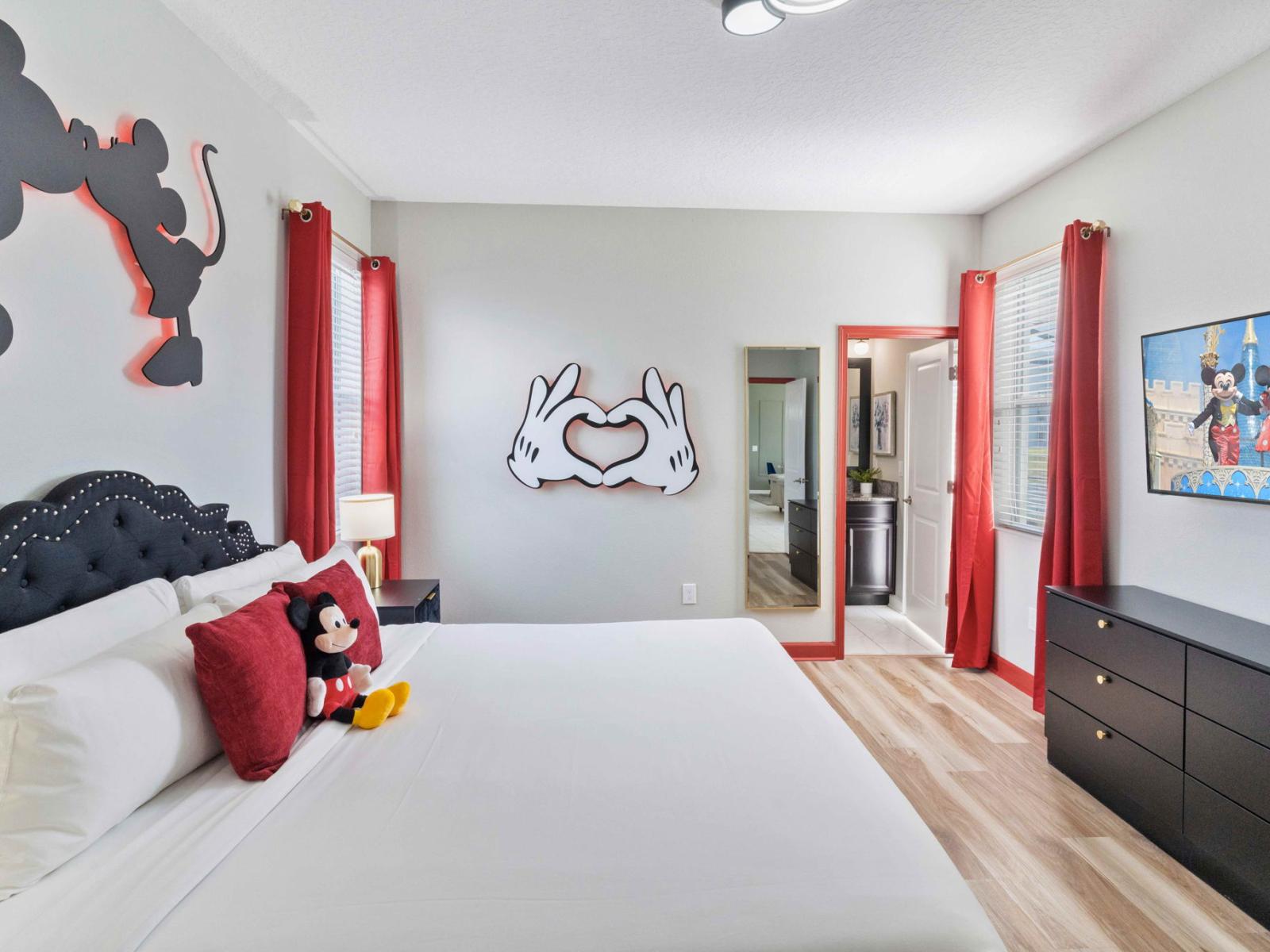 Mickey and Minnie themed bedroom with king size bed and smart TV