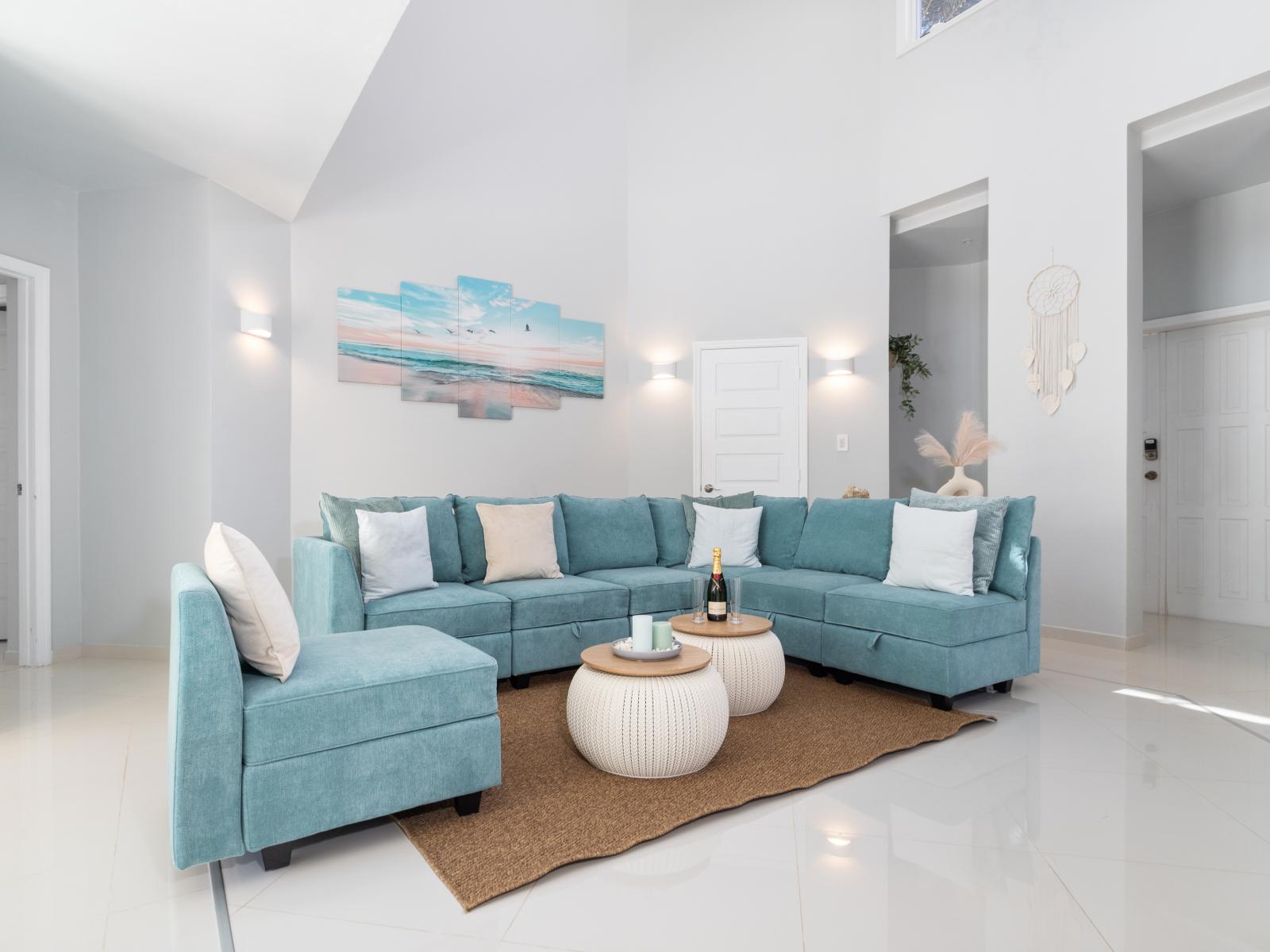 Luxurious living area of the villa in Noord Aruba - Cosy sofas - Elegantly decored living area - Large bright windows of the living area with Mesmerizing views - Beautifully furnished floor - Availability of TV and Netflix