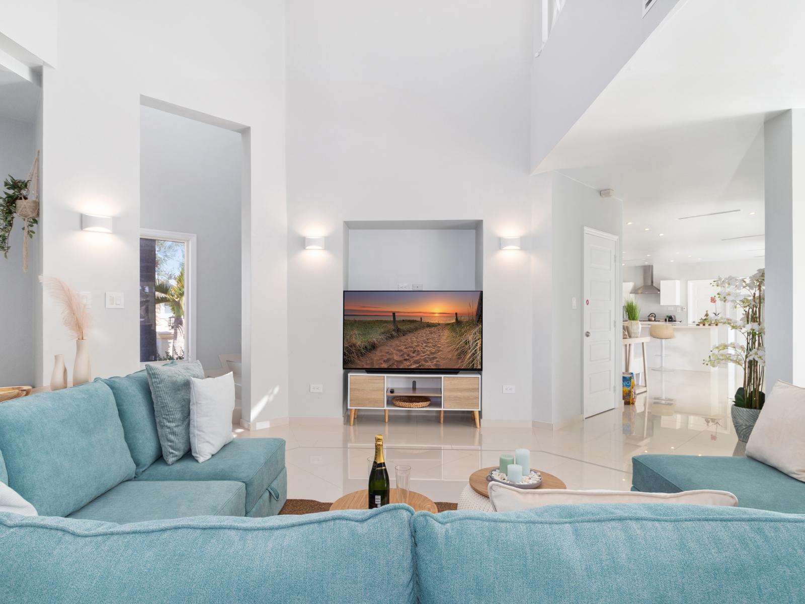 Cozy living area of the villa in Noord Aruba - Comfy sofas - Elegantly decored living area - Large bright windows of the living area with Mesmerizing views - Beautifully furnished floor - Availability of TV and Netflix