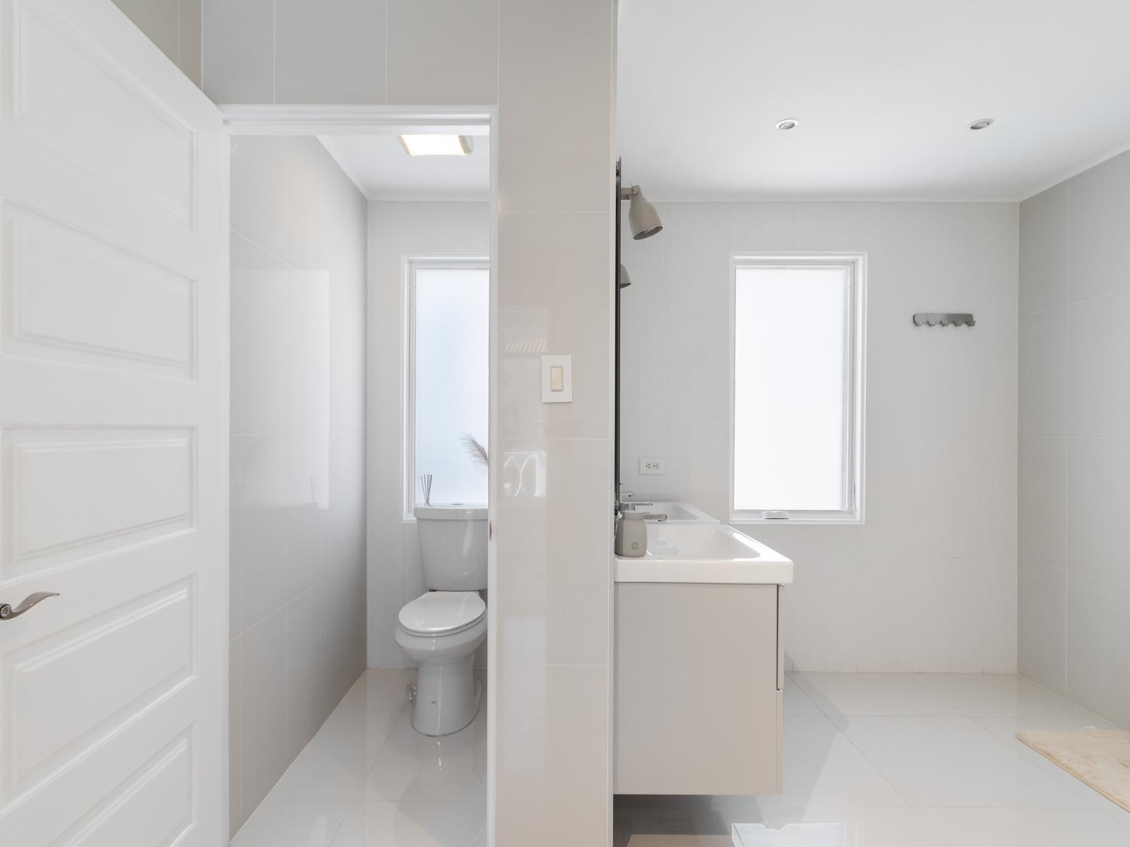 High-class Bathroom of the villa in Noord Aruba - Beautiful Vanity with large size wall mirror - Sufficient storage space - Neat and clean toilet seat - Availability of all bathroom amenities - Stunning shower area