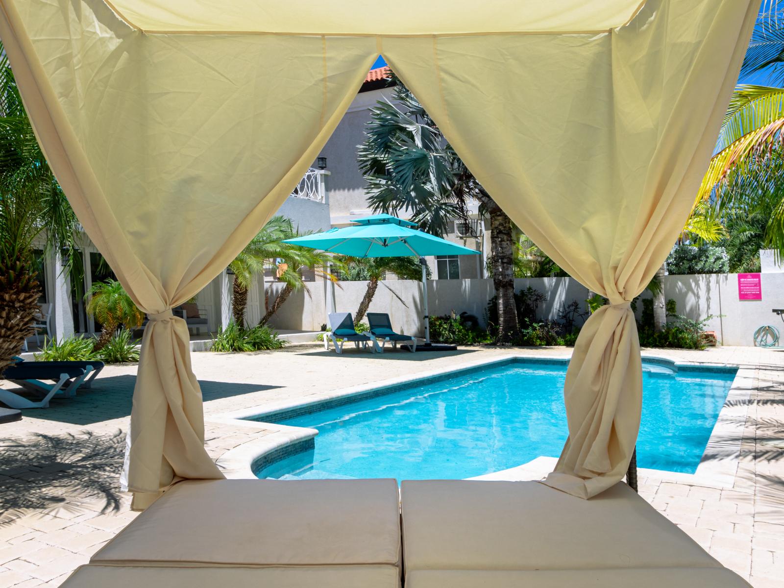 Day bed next to the pool. Just waiting for you!