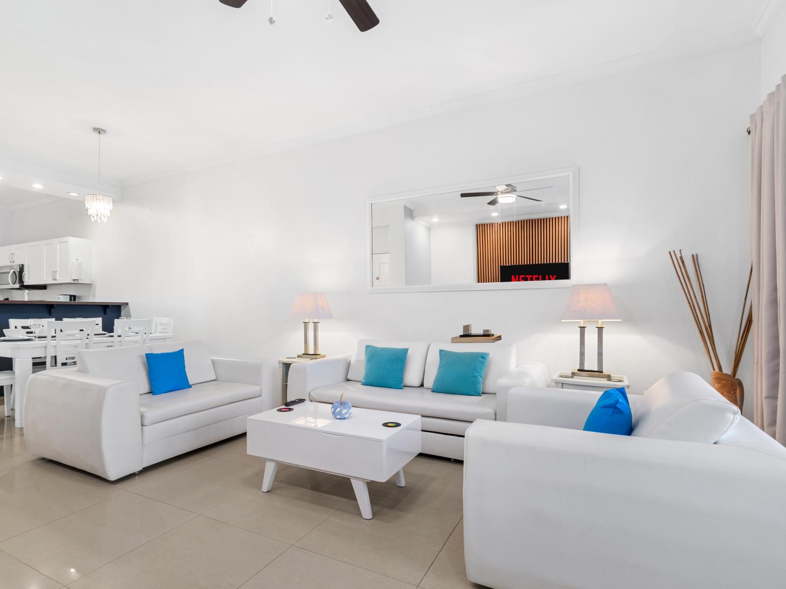 Breathtaking Living Area of the 2BR Condo in Noord Aruba - Elegantly decorated space with a neutral color palette for a timeless appeal - Living area is fully furnished with luxurious amenities - Smart TV and Netflix