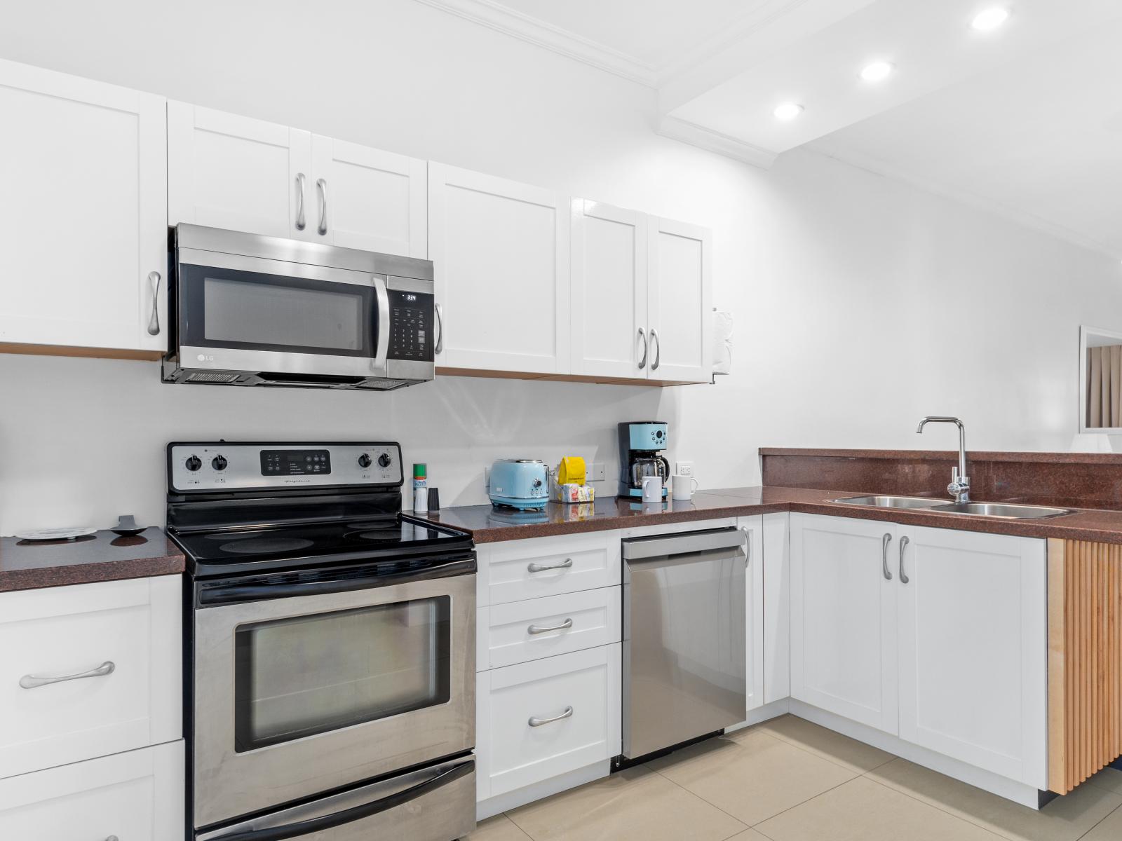 Enchanting Kitchen of the 2BR Condo in Noord Aruba - Fully equipped kitchen with stainless steel appliances - Integrated appliances for a seamless and stylish appearance