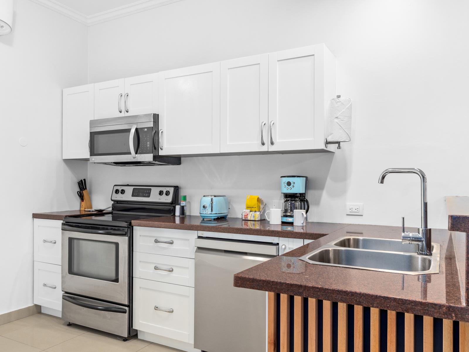 Modern Kitchen Area of the 2BR Condo in Noord Aruba - Fully Equipped - Functional layout designed - Integrated appliances for a seamless and stylish appearance - Open concept connecting the kitchen to the Dining and Living Area