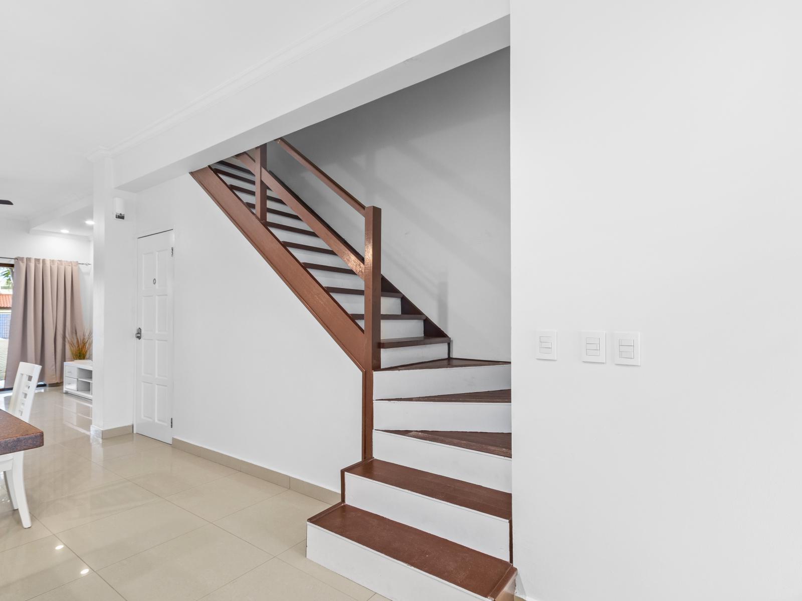 Stairs to the second floor going to the bedrooms - Luxurious decor for a lavish ambiance - Cozy and inviting atmosphere with warm earthy tones - Well-planned layout maximizing comfort and functionality