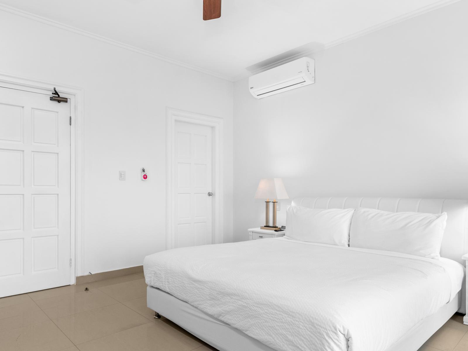 Deluxe bedroom of the 2BR Condo in Noord Aruba - Comfy King Size Bed - Bedroom with a cozy ambiance, blending comfort and aesthetics - Then Bathroom - Private Balcony