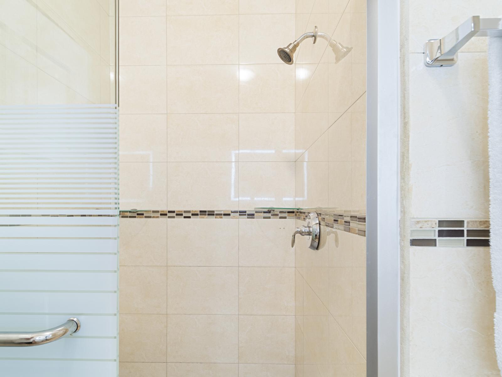 Chic Bathroom of the 2BR Condo in Noord Aruba - Glass-enclosed Walk-in Shower - Contemporary fixtures for a touch of indulgence - Attention to detail, from the elegant tiles to the faucets