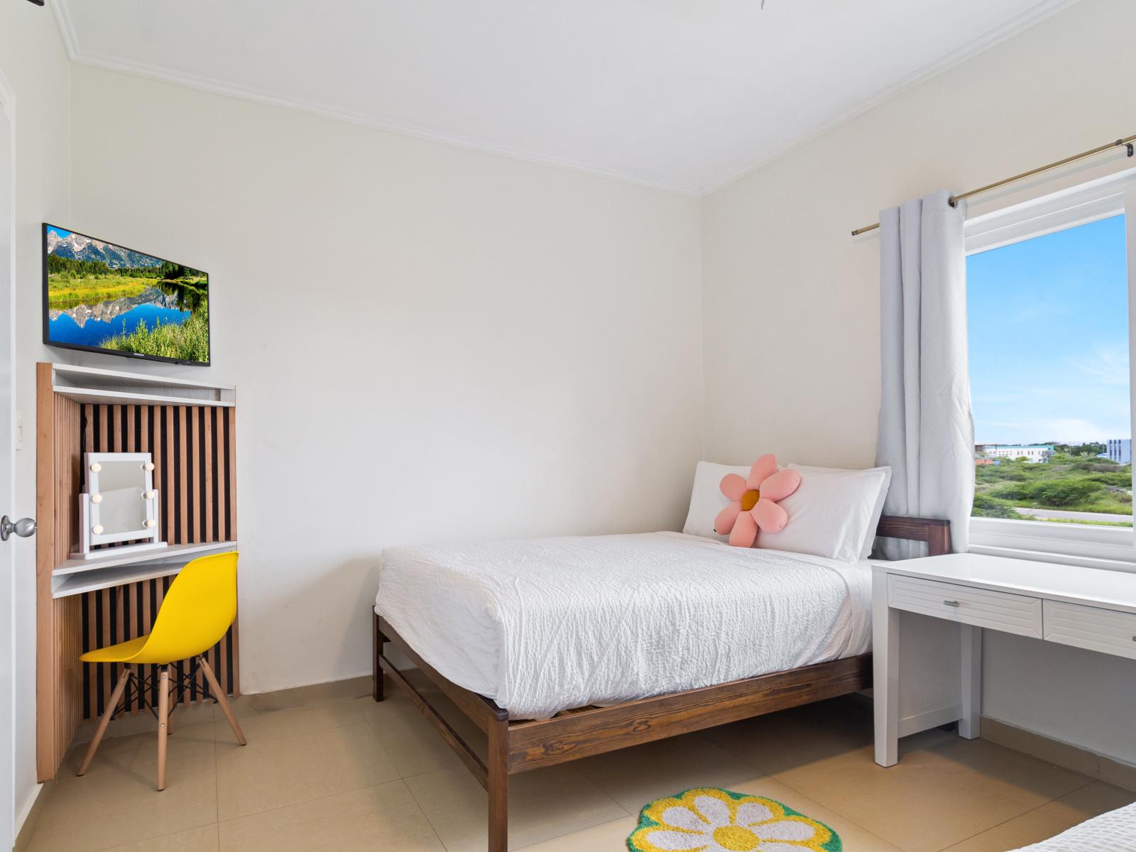 Plush Bedroom of the 2BR Condo in Noord Aruba - Smart TV and Netflix - Modern bedroom with sleek design and natural light - Smart use of space with efficient storage solutions