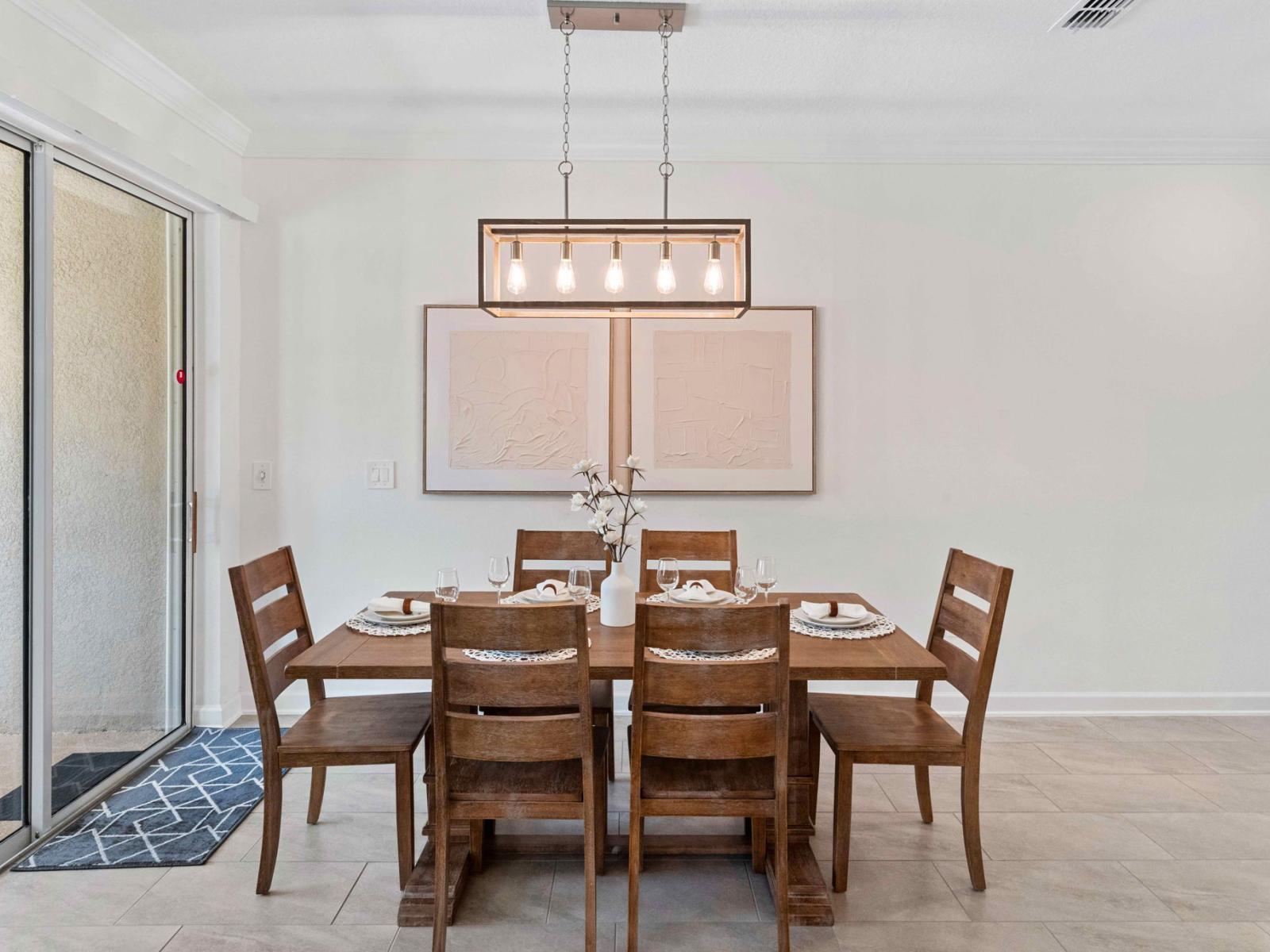 Sleek dining area of the townhouse in Kissimmee Florida - Dining for 6 persons - Thoughtful lighting fixtures creating an intimate and inviting atmosphere - Harmonious color scheme for a cohesive and stylish look