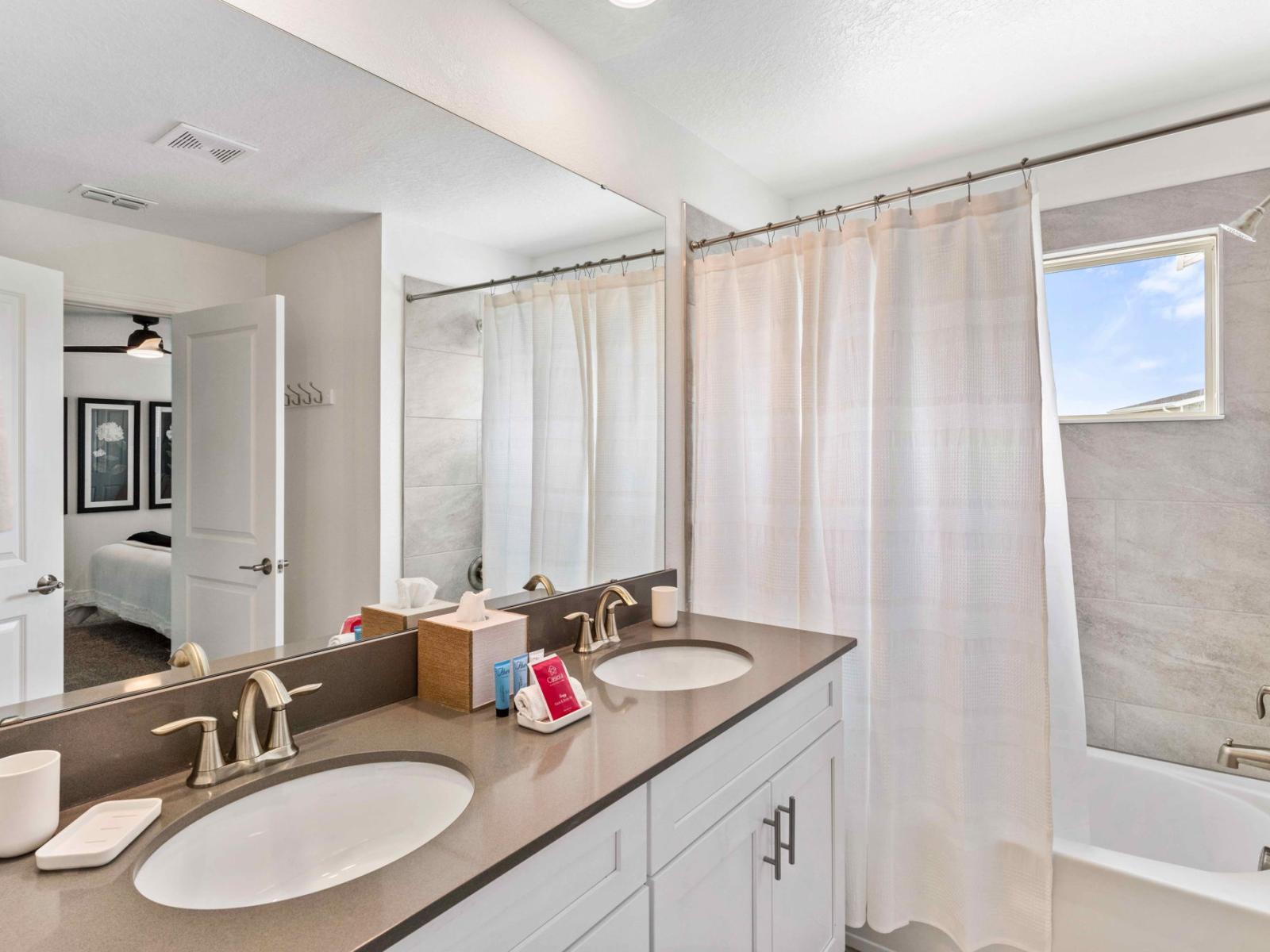 Spacious main bathroom featuring both a shower and a bathtub for your convenience.