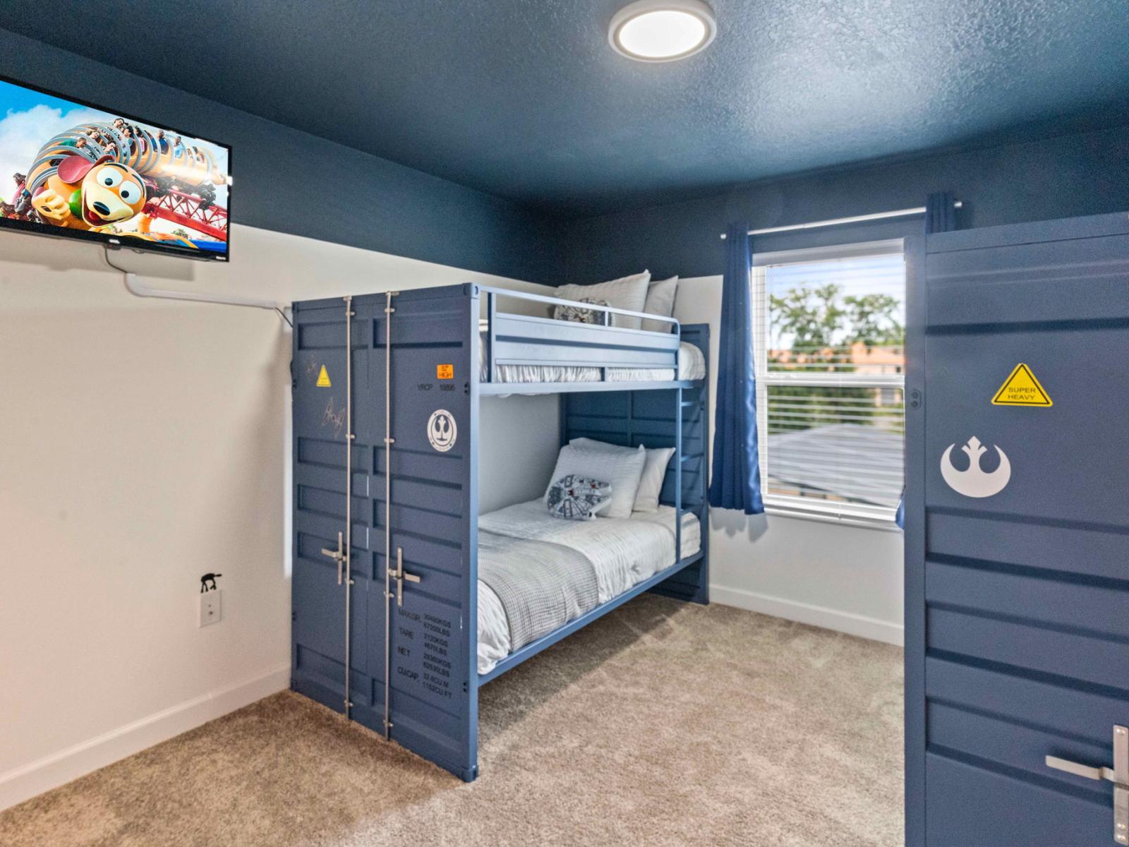 Fourth bedroom featuring four single bunk beds and a smart TV, perfect for group accommodations.