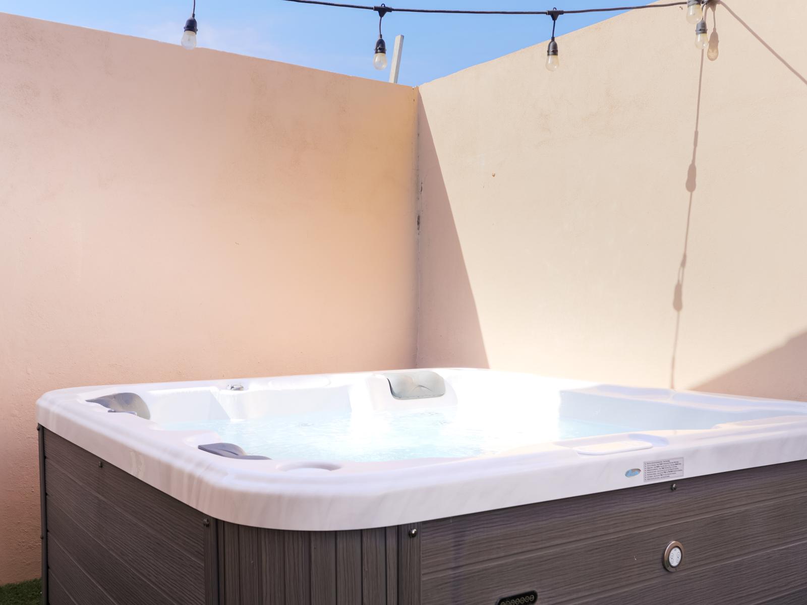 Enjoy a dip in the Hot tub and relax - Experience ultimate relaxation - Inviting tub for a perfect getaway - Sleek and stylish