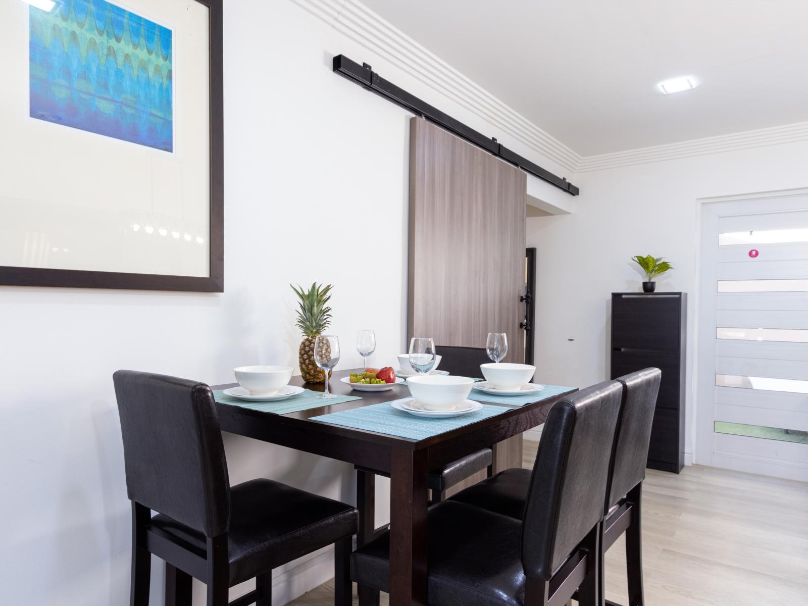 Resplendent Dining Area of the 3BR House in Oranjestad Aruba - Chic dining area featuring a stylish table and seating - Artfully arranged table settings for a touch of elegance - Customized decor reflecting a sophisticated design sensibility