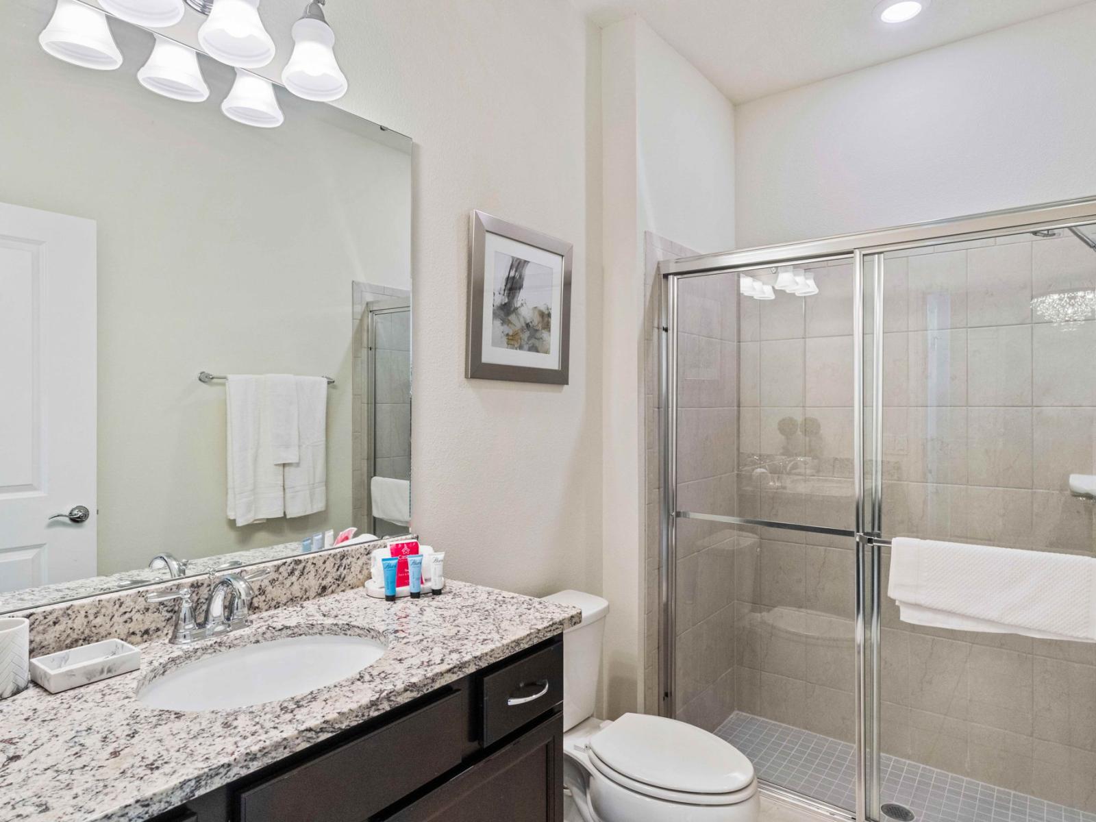 Bathroom 1 offers a serene retreat with its spacious shower. A tranquil oasis where cascading water rejuvenates the senses, promising moments of relaxation and renewal.