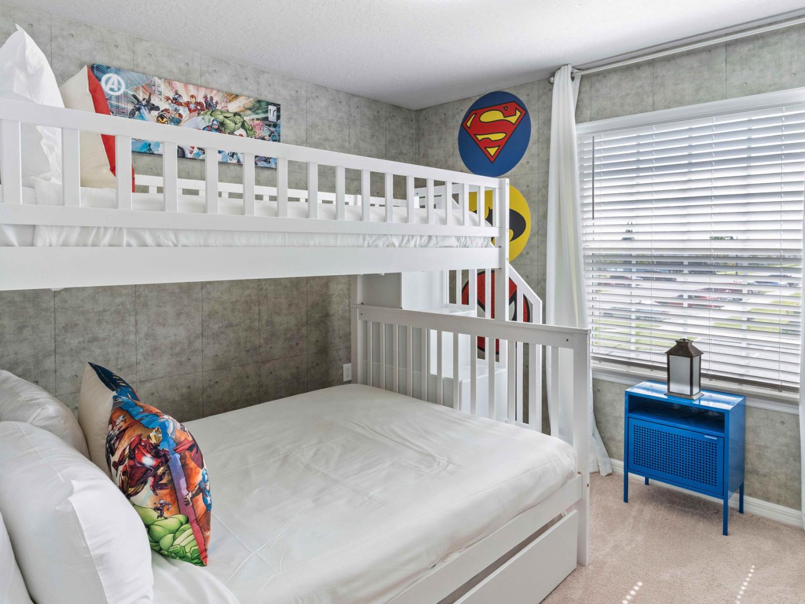 Bedroom 4 welcomes with a playful Super Hero accent wall and a bunk bed featuring both a single and double mattress. It's a vibrant haven where imagination runs wild and dreams of superhero escapades come to life.