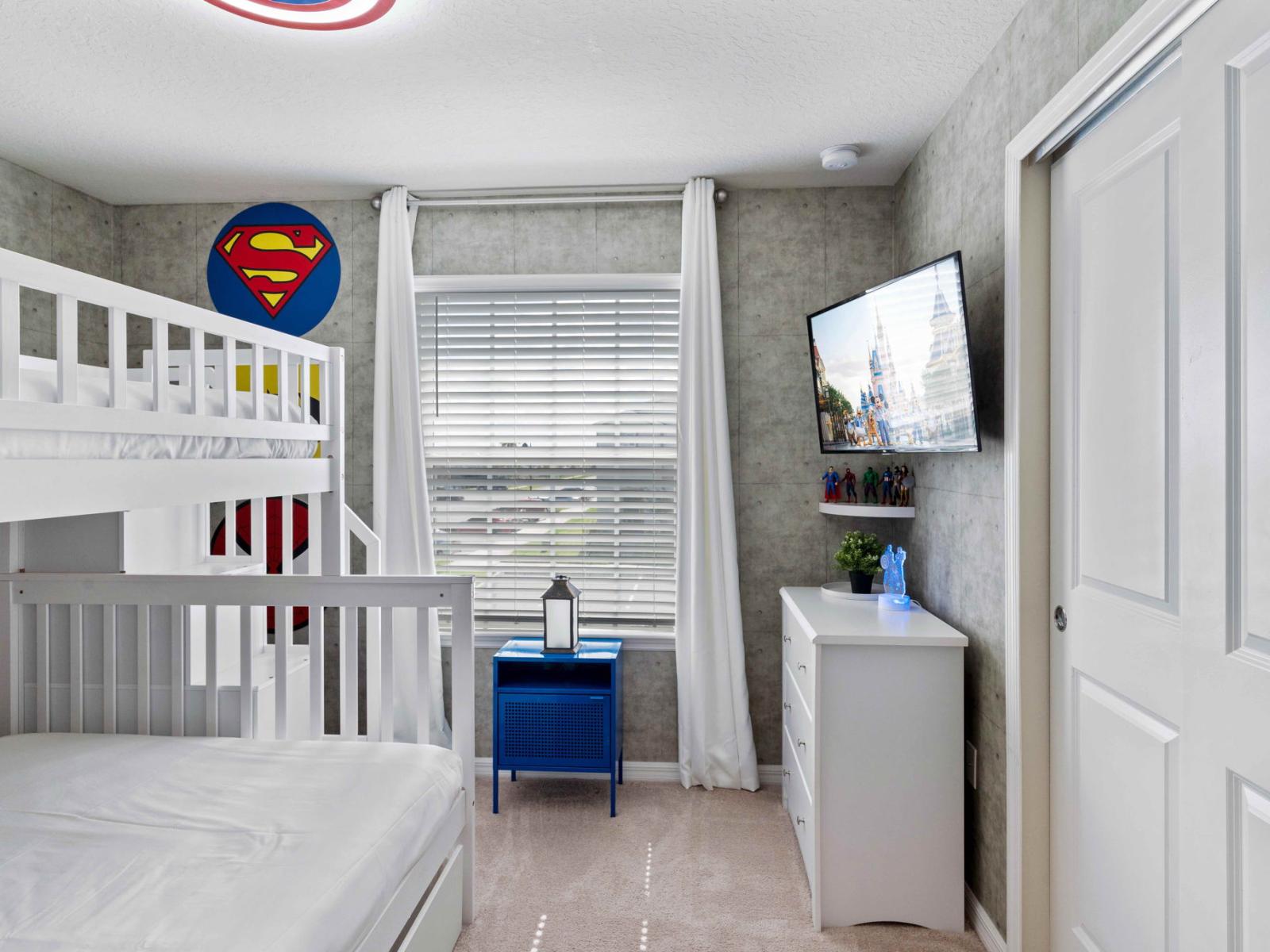 Bedroom 4 welcomes with a playful Super Hero accent wall and a bunk bed featuring both a single and double mattress. It's a vibrant haven where imagination runs wild and dreams of superhero escapades come to life.