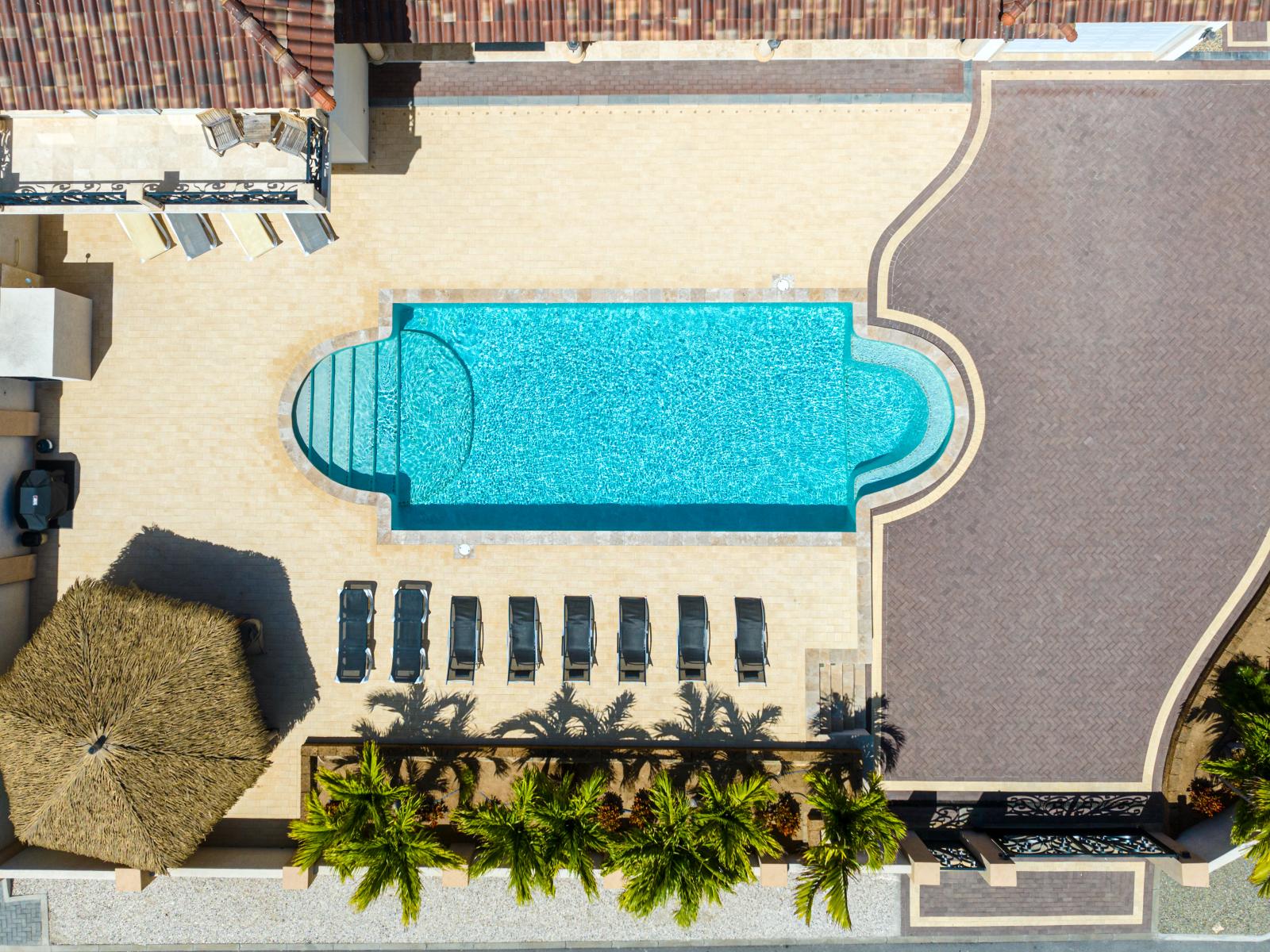 Experience serenity from above: a breathtaking aerial view of our inviting pool oasis.