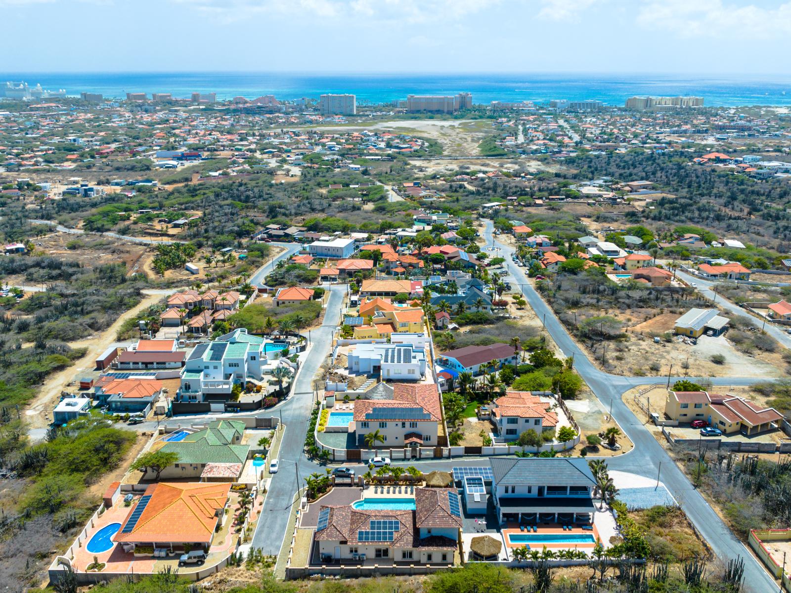 Capture the essence of luxury: behold our property from a mesmerizing aerial perspective, where lush landscapes and elegant architecture merge to create an enchanting retreat.