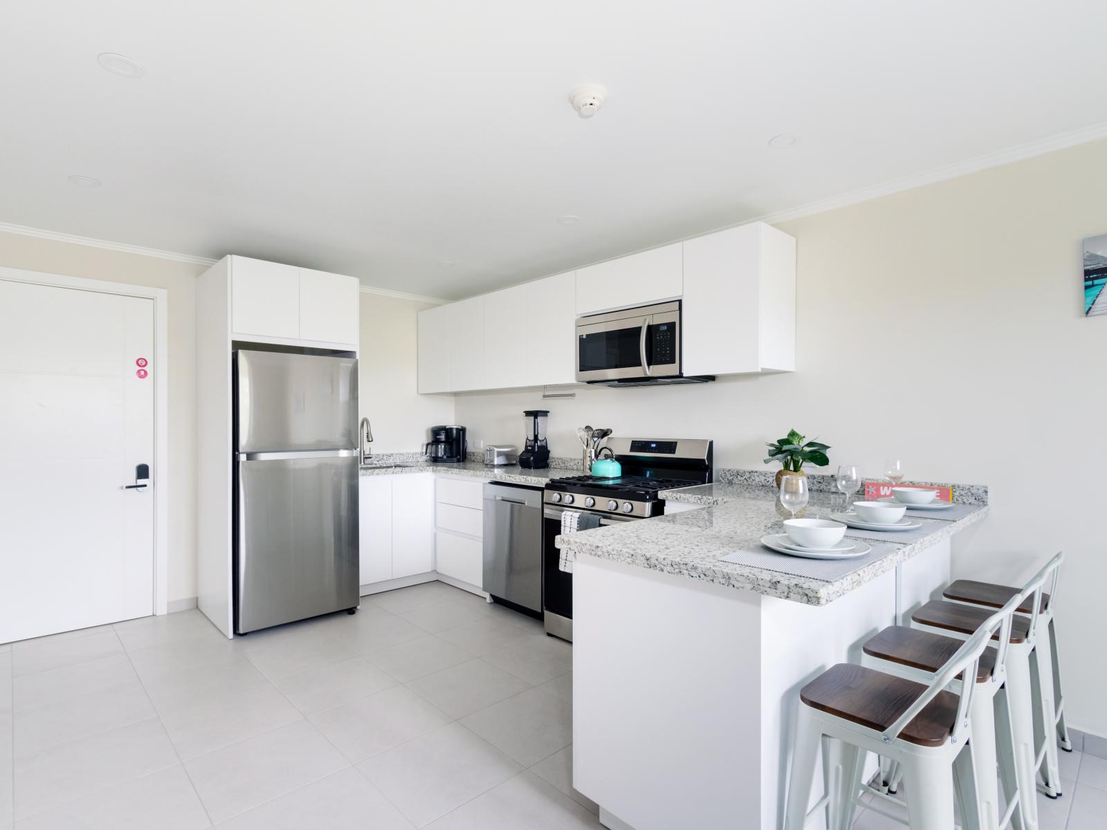 Gorgeous Kitchen of the 2-BR Condo in Noord Aruba - Smart use of space with versatile storage solutions - Open concept connecting the kitchen to the dining or living area - Thoughtful placement of kitchen essentials for easy access - Meal Bar