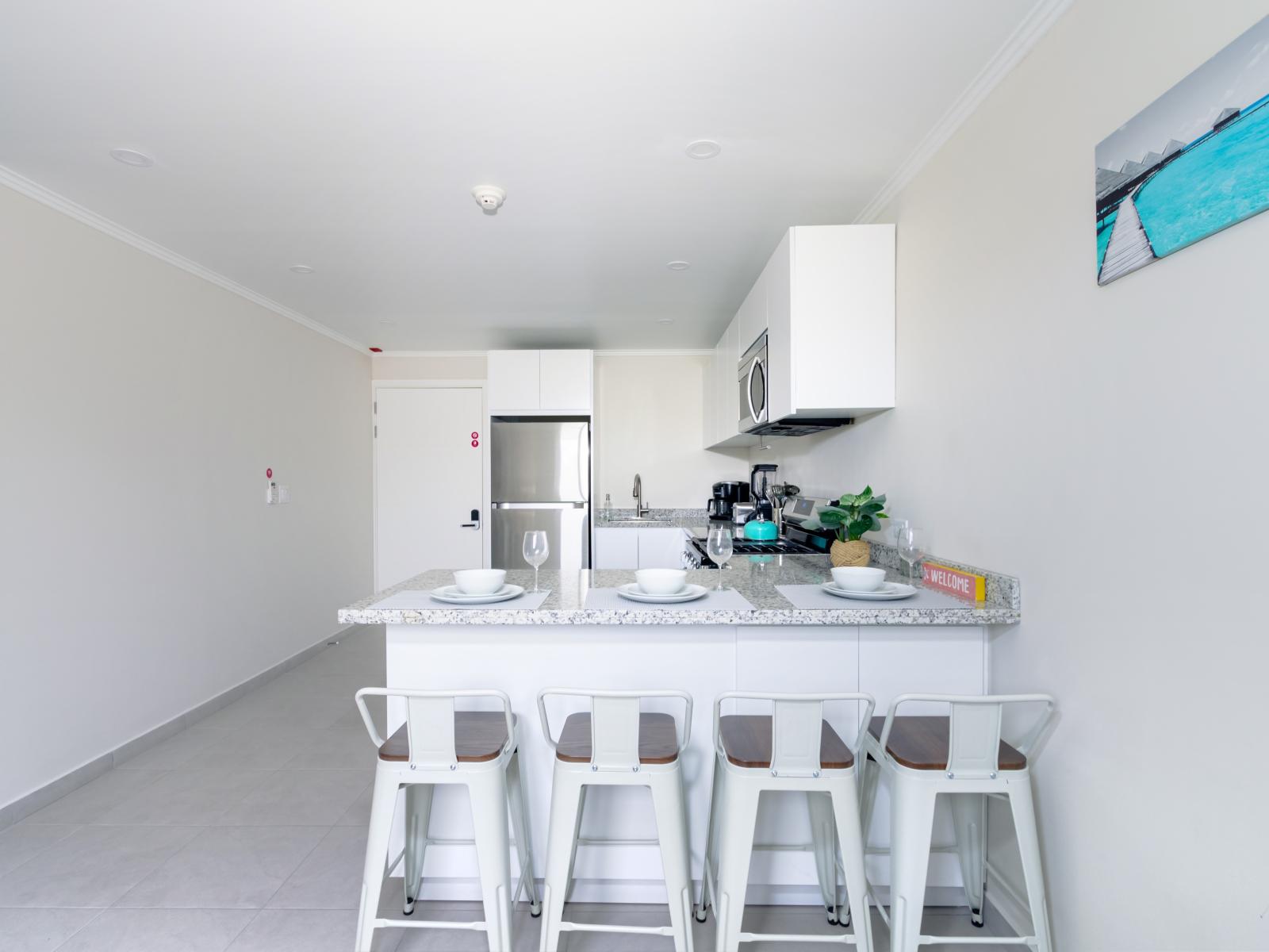 Modern Kitchen of the 2-BR Condo in Noord Aruba - Well-lit space with strategically placed task lighting - Elegant and coordinated color palette for a cohesive look - Fully Equipped