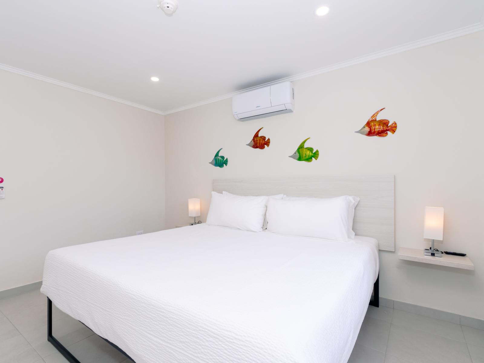 Make yourself at home in our stylish first bedroom, equipped with a king bed and TV for your enjoyment.