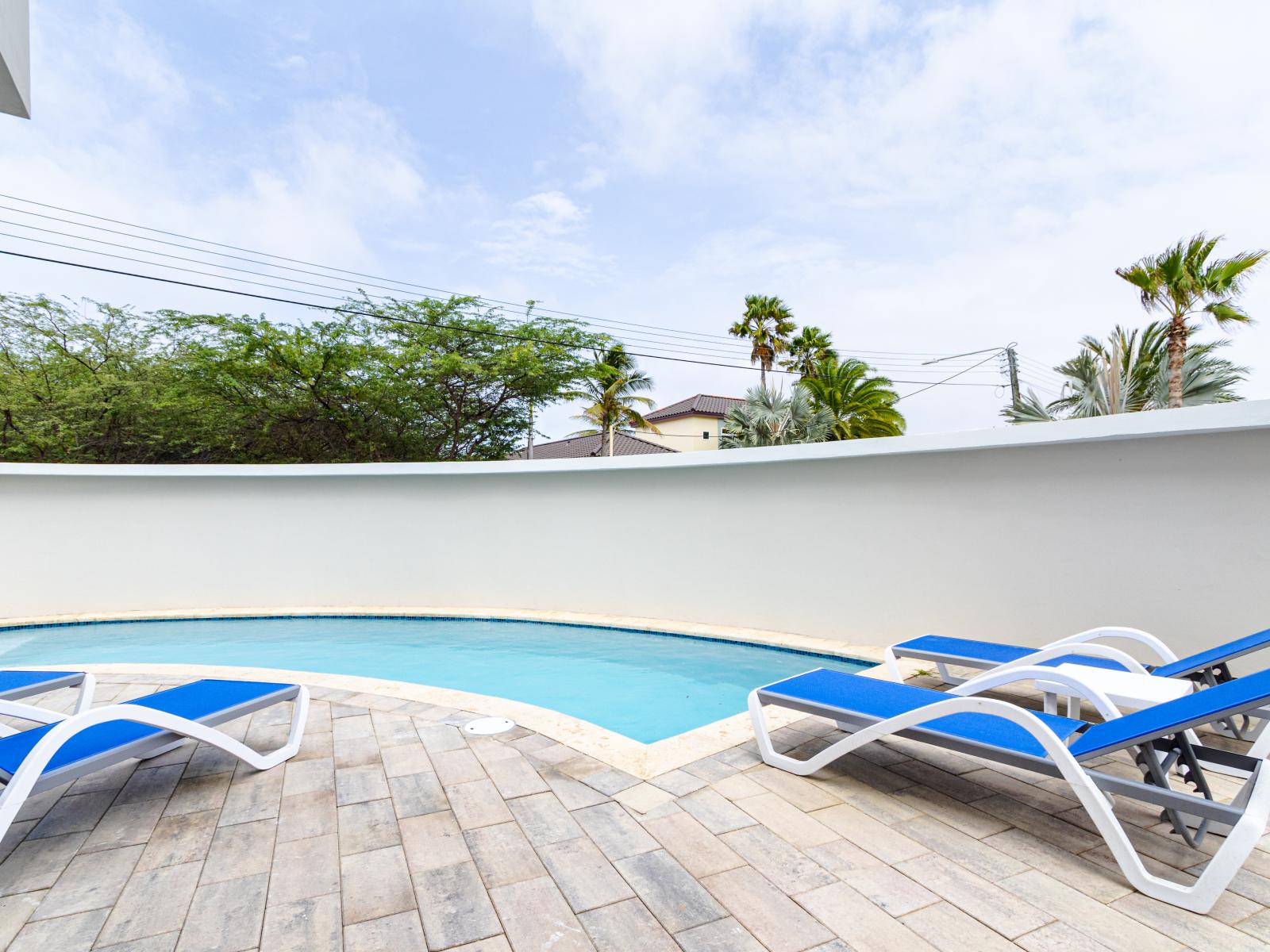 Our outdoor shared pool and hot tub offer a refreshing retreat for guests seeking relaxation and leisure.