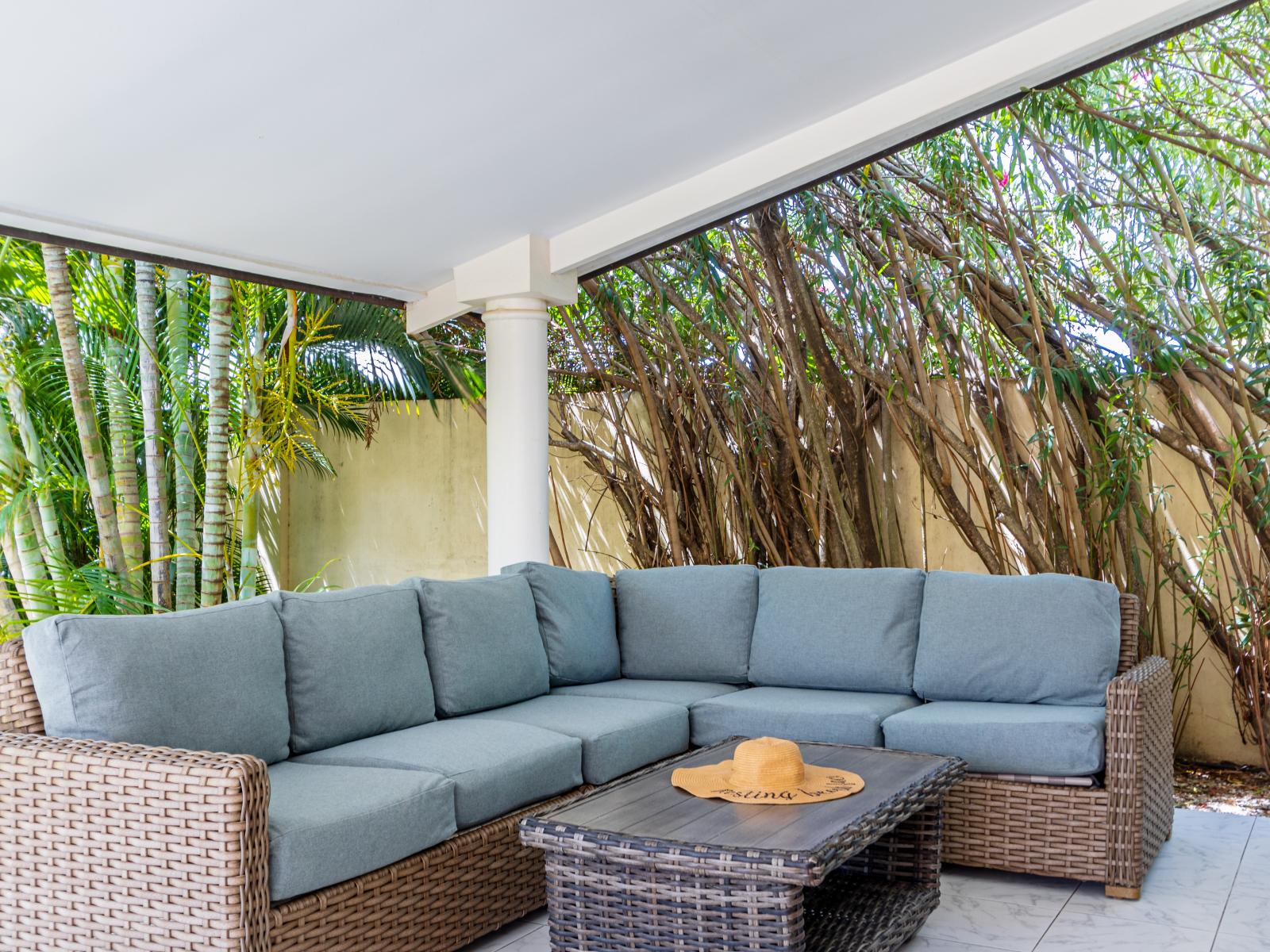 Plush Outdoor seating area of the Villa in Noord Aruba - Plush seating arrangements invite relaxation and stylish gatherings - Refreshing Atmosphere