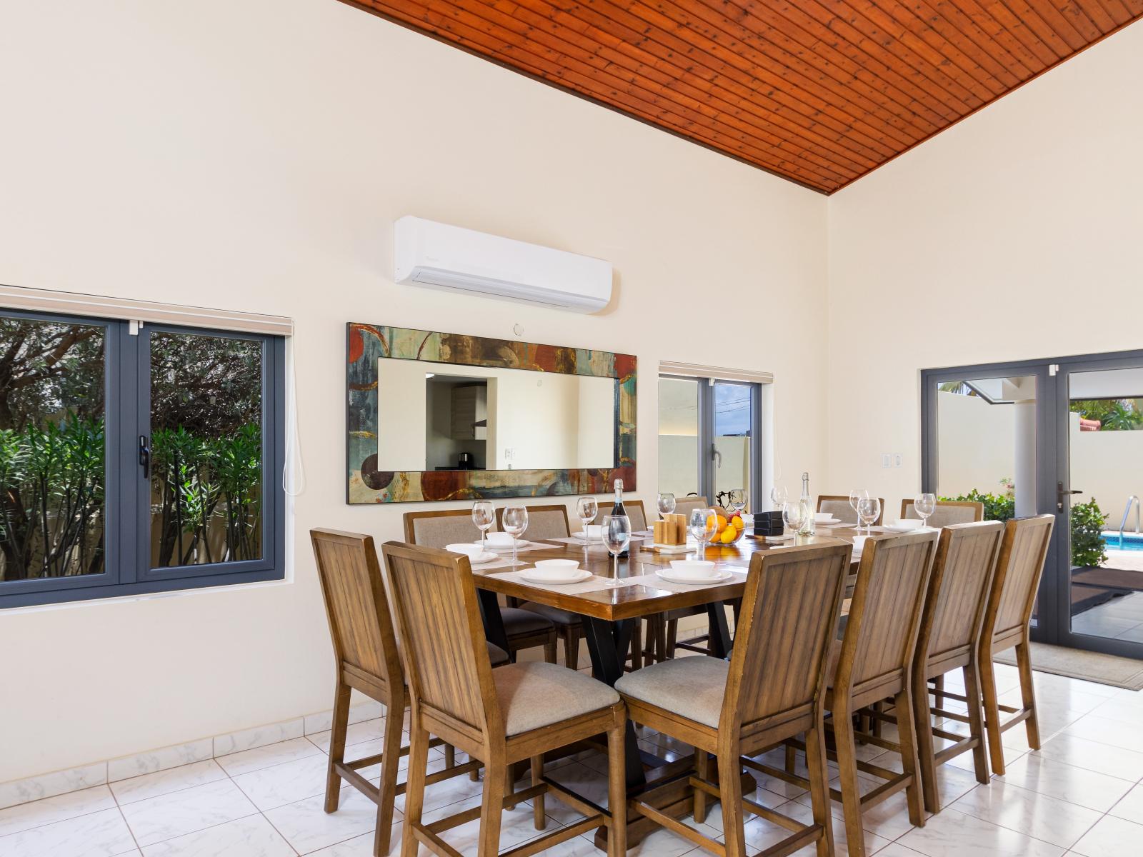 Charming Dining Area of the Villa in Noord Aruba - 14 Persons Dining - Quality materials, such as a sleek dining table and comfortable chairs - Modern Design - Intimate ambiance created through soft, ambient lighting