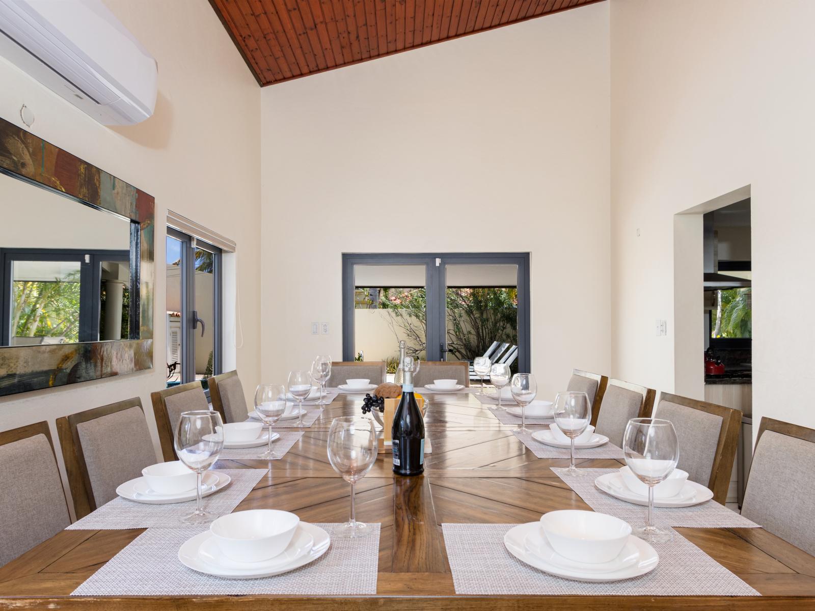 Ornamental Dining Area of the Villa in Aruba - 14 Persons Dining - Thoughtful lighting fixtures creating an intimate and inviting atmosphere - Artfully arranged table settings for a touch of elegance